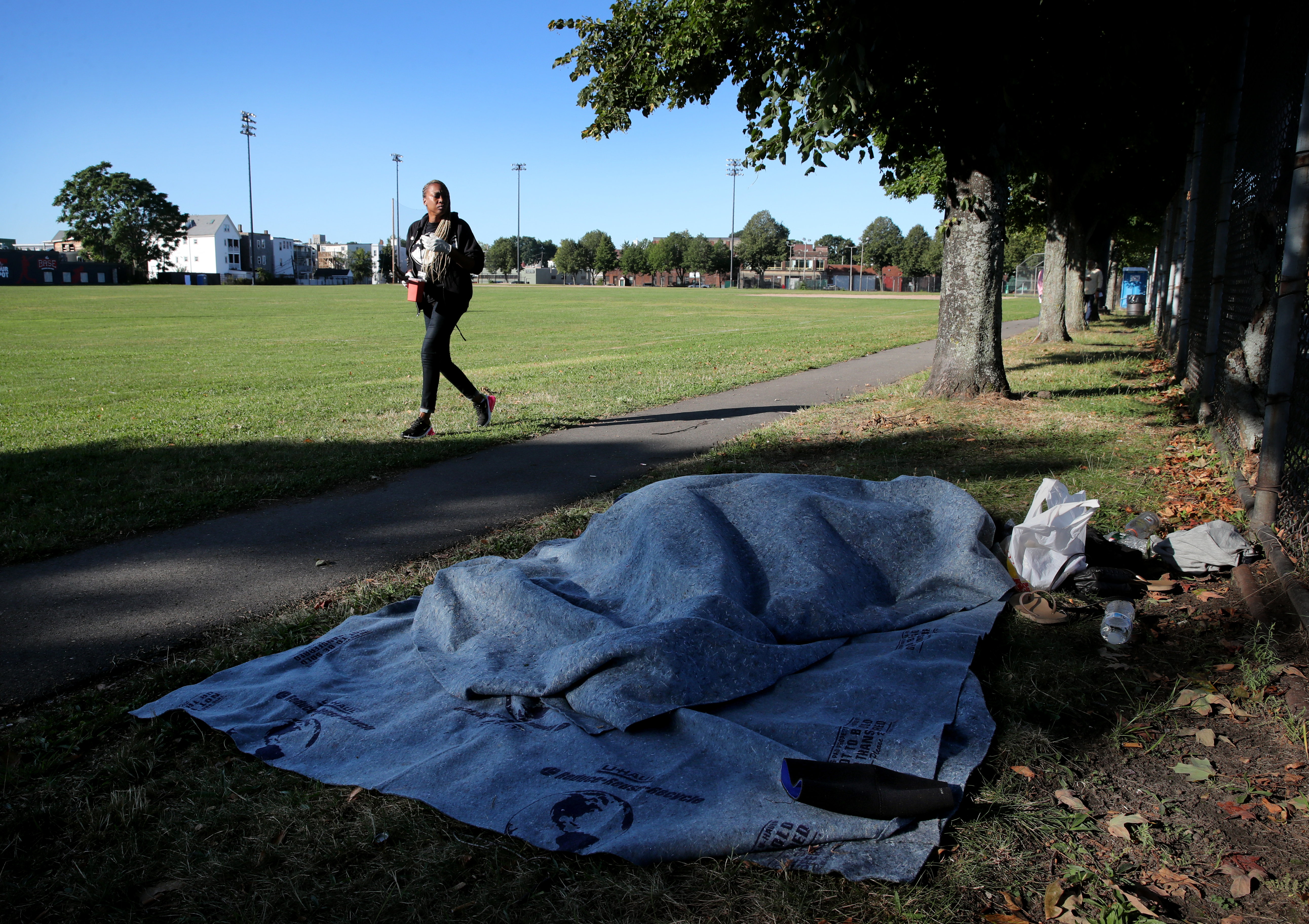Shanita, a coordinator for the AHOPE Sharps team, passed a person sleeping in Clifford Playground while looking for discarded needles.
