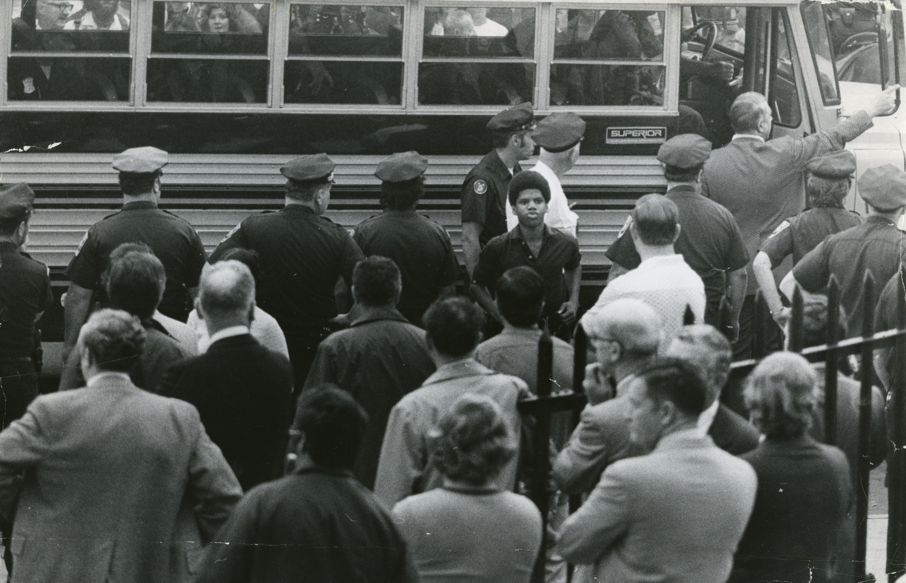 Police officers were deployed to escort a black student arriving at South Boston High School on Sept. 12, 1974, the first day of busing under a federal desegration order.