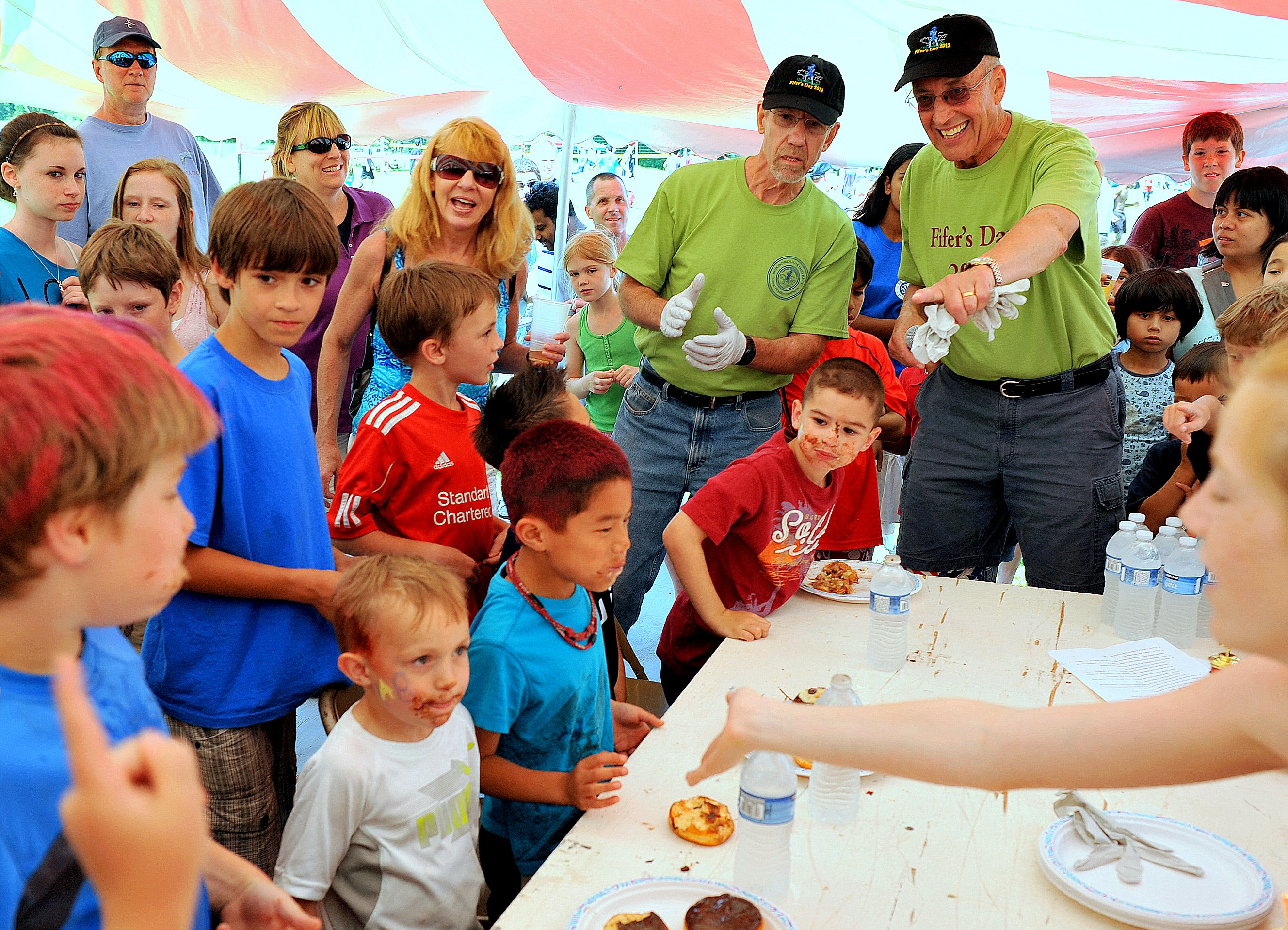 Kids take part in a hands-free donut eating contest as part of Boxborough's Fifer's Day festival.
