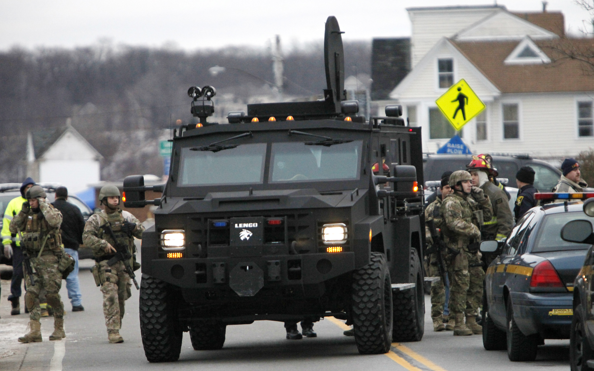 A Lenco Monroe County Sheriff's Department armored truck dropped off residents who were evacuated from the neighborhood, in Webster, N.Y. Dec. 24 after a former convict set a house and car ablaze ito lure firefighters, then opened fire on them, killing two.