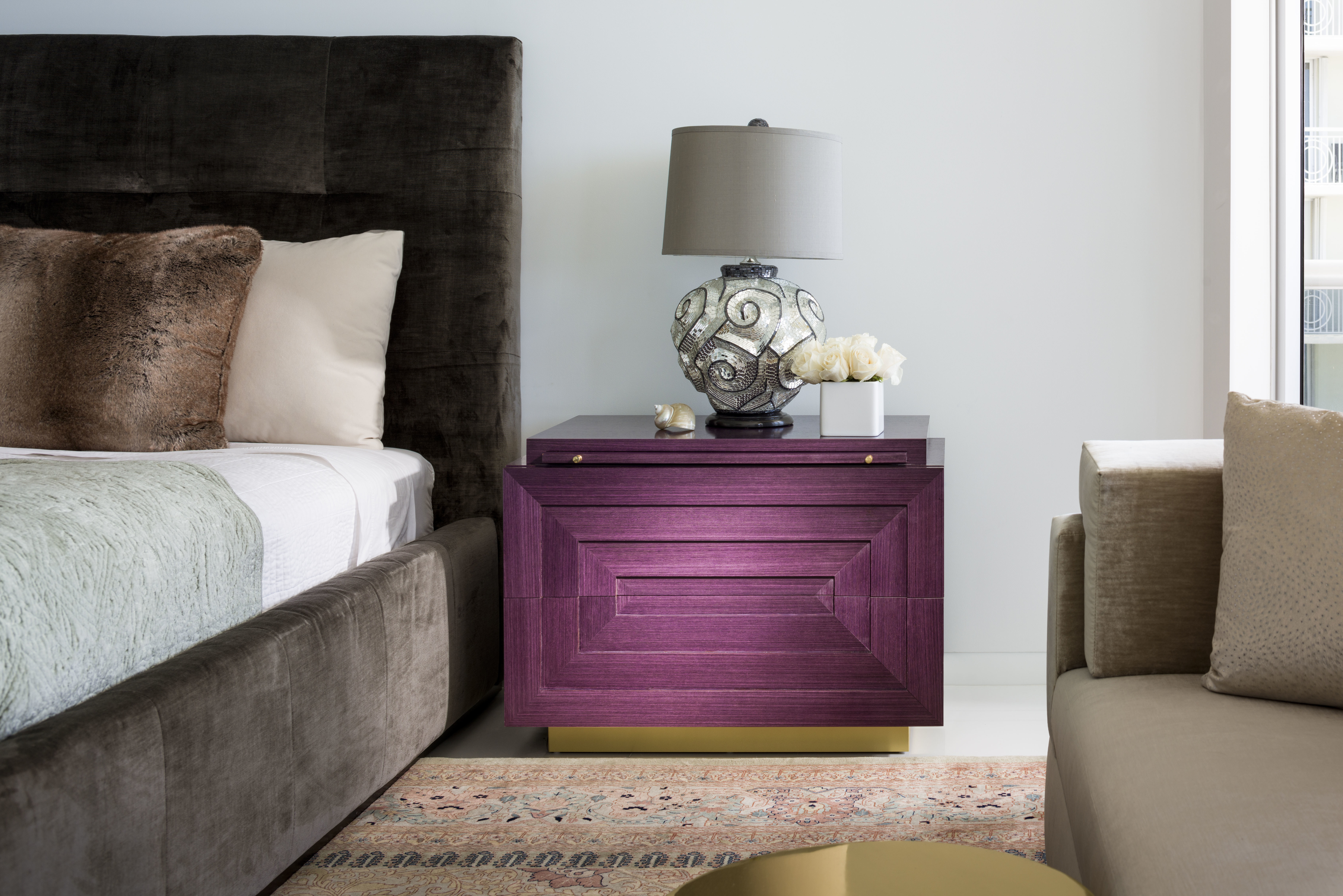 A rich purple console in a penthouse apartment bedroom.