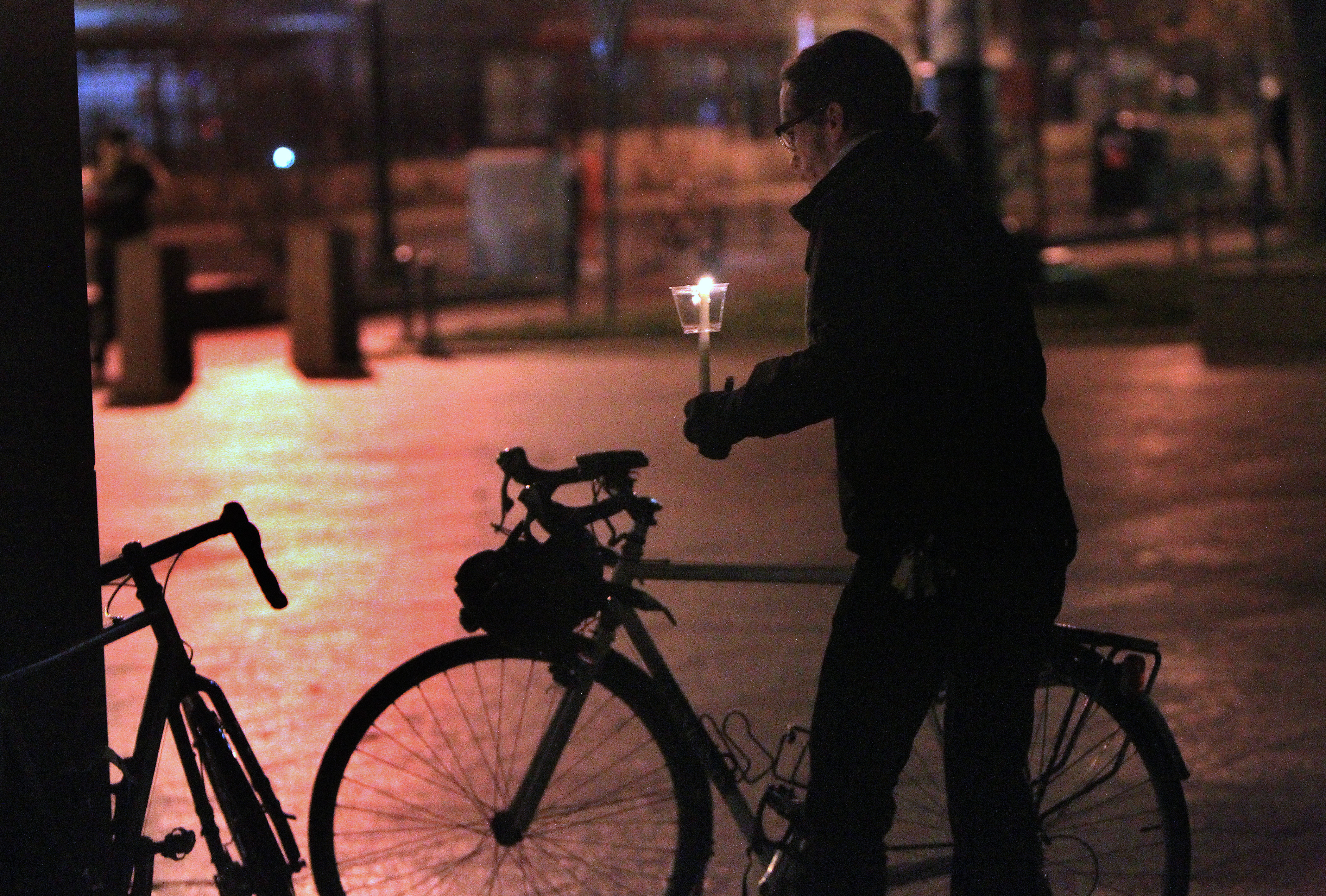 A bicyclist joined in the vigil for Christopher Weigl.