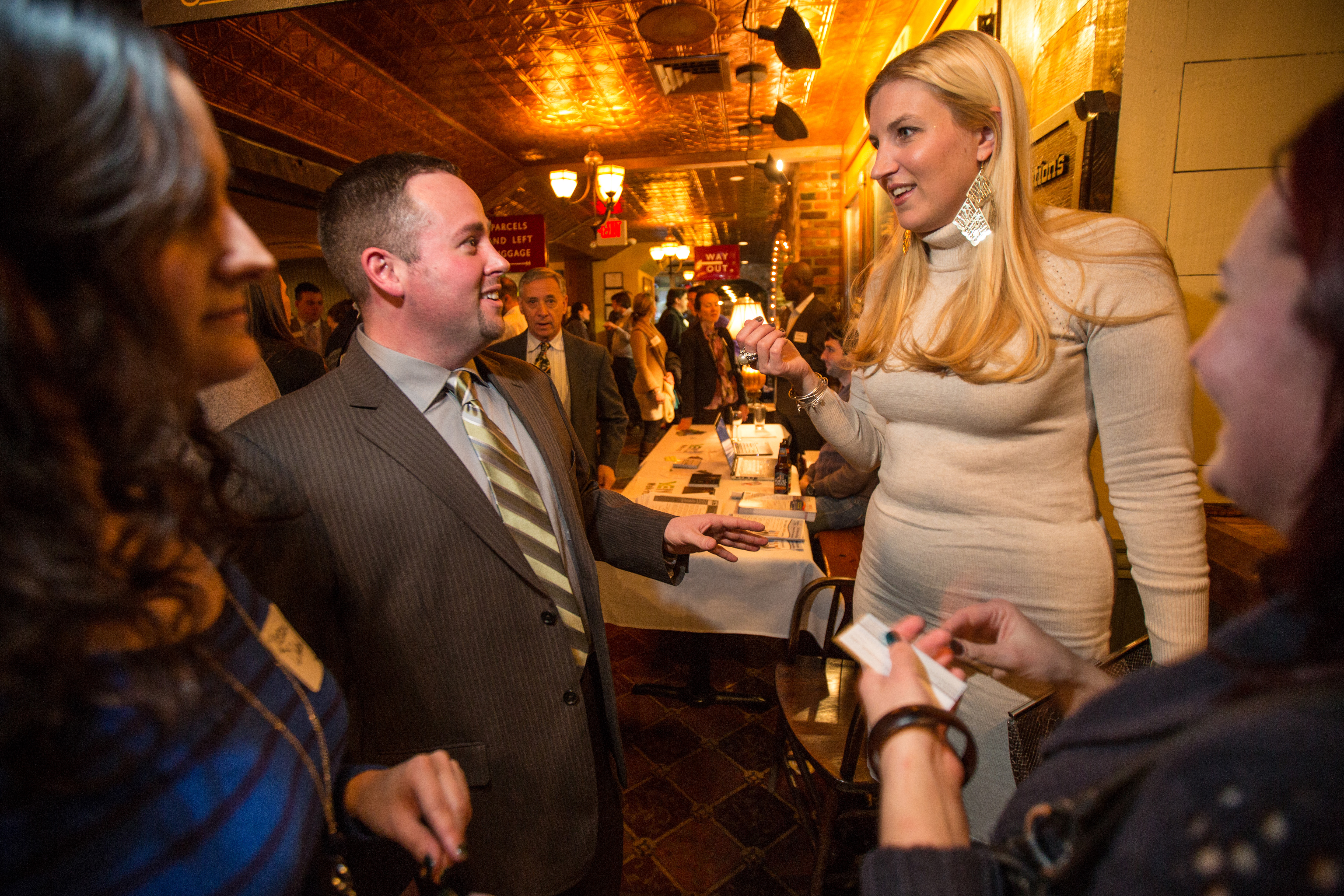 President Andrew E. Turner (left), speaks with Julia Campbell, of J Campbell Social Marketing, during a Young Entrepreneurs of the North Shore event held at Victoria Station in Salem.