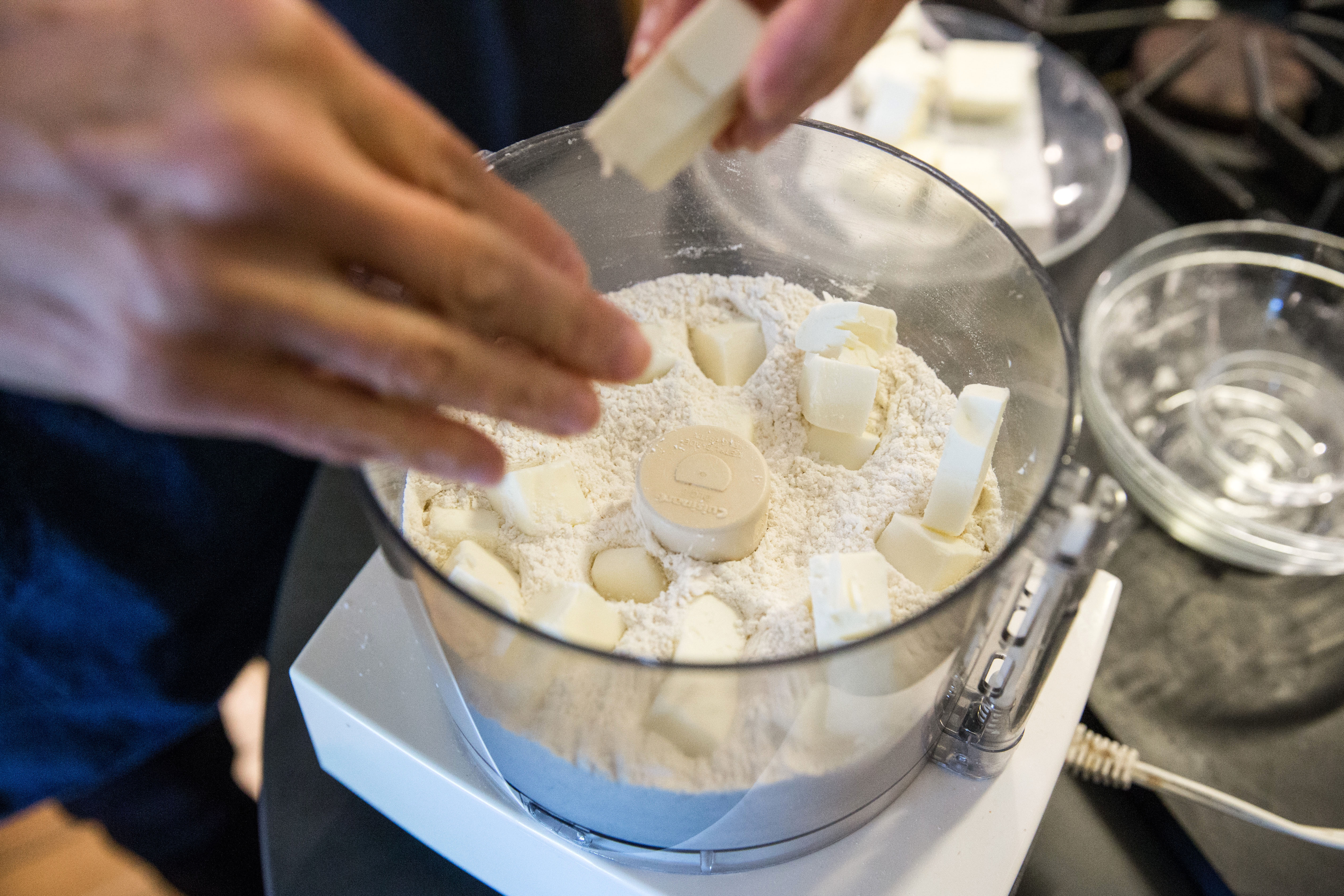 Combining flour, salt, and butter in a food processor.
