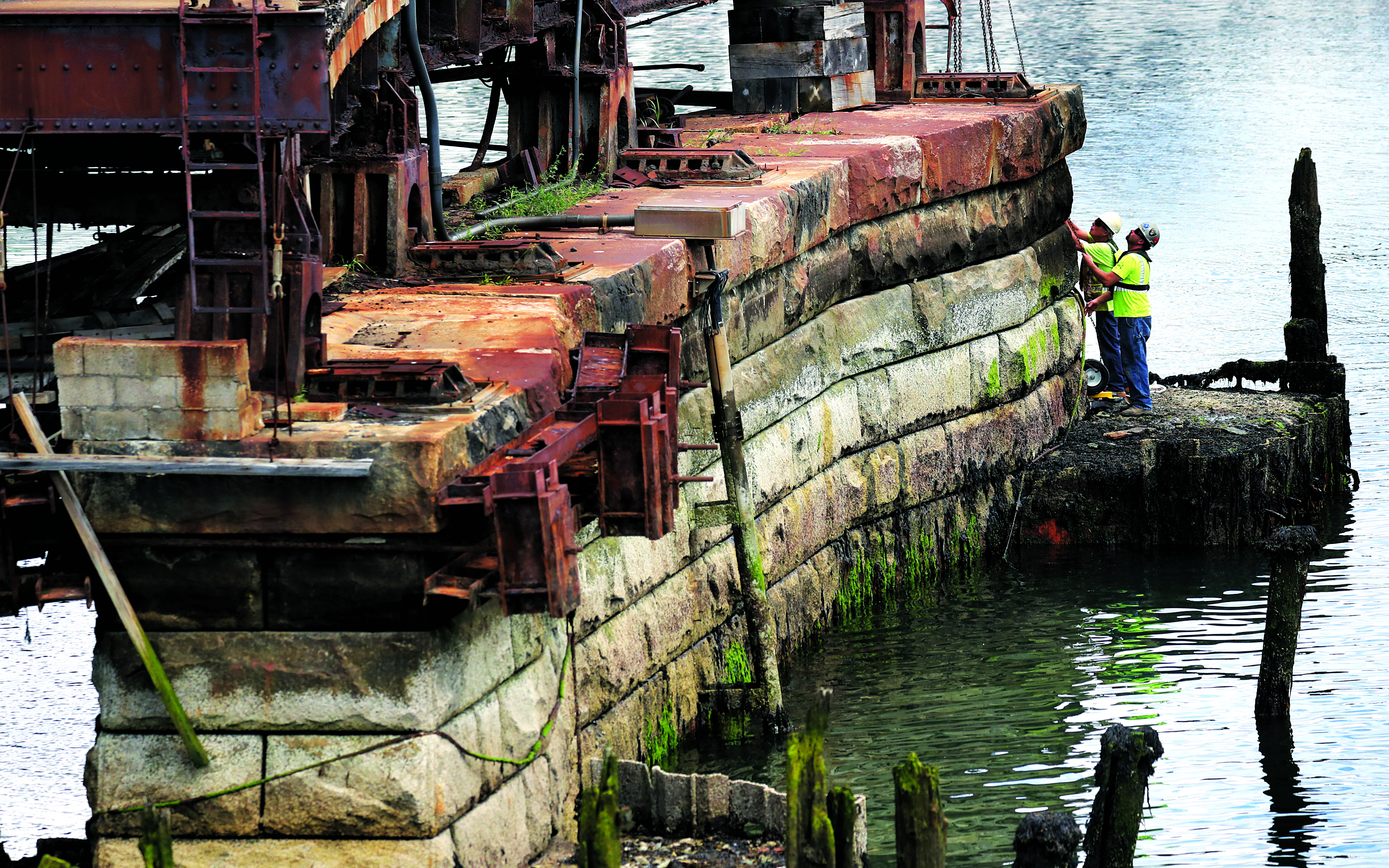 Workers were busy last week along the supports of the bridge, which was built in 1908.