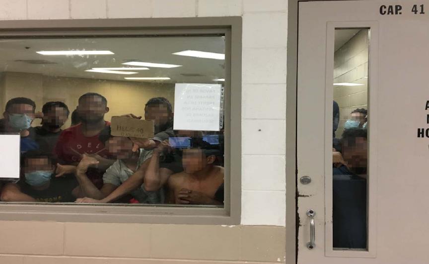 Eighty-eight adult men were held in a cell built for 41. One man held up a sign indicating he’d been there for 40 days.