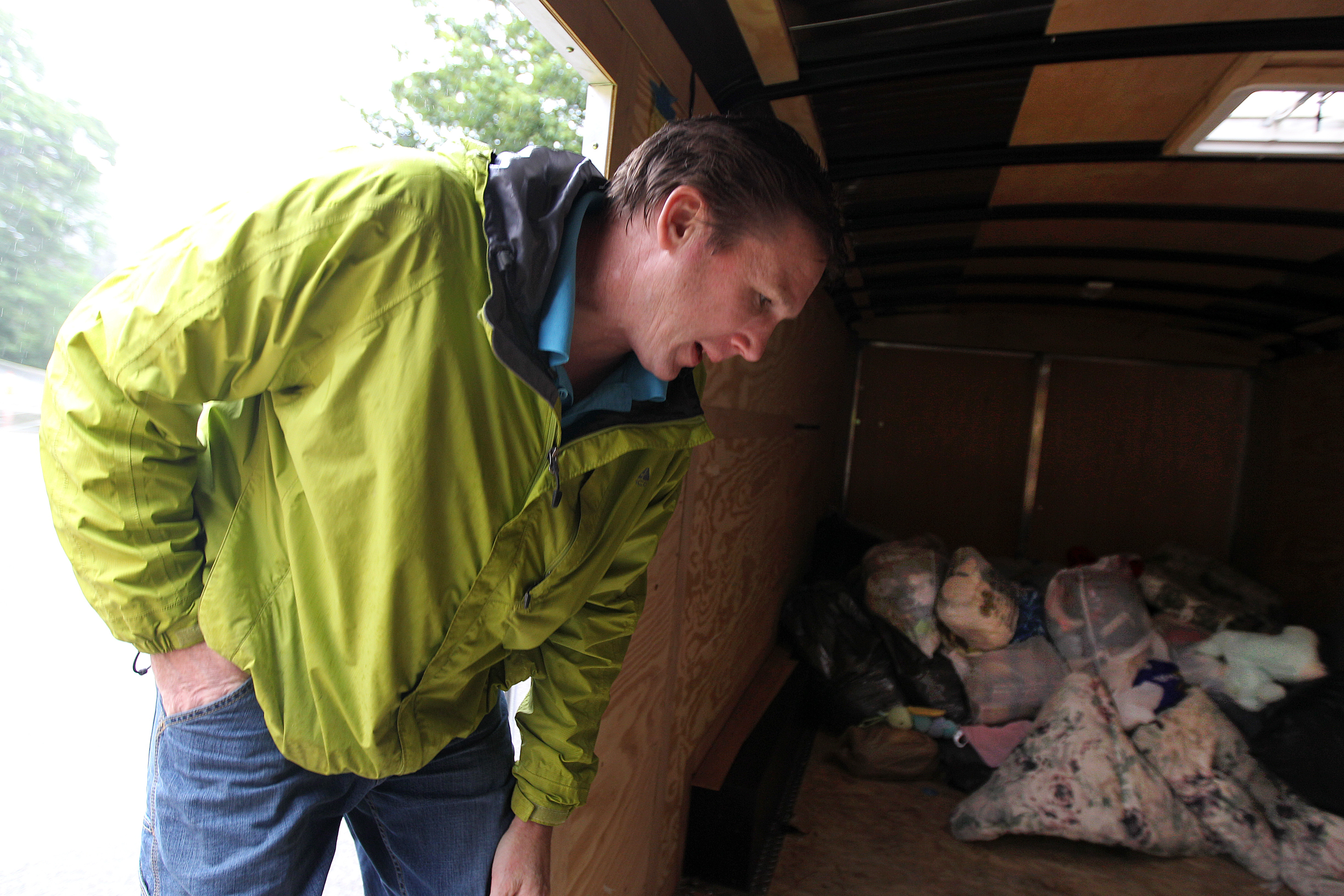 Steven Hansen, who works for Bay State Textiles, looked over donations left at Weymouth’s Academy Avenue School.
