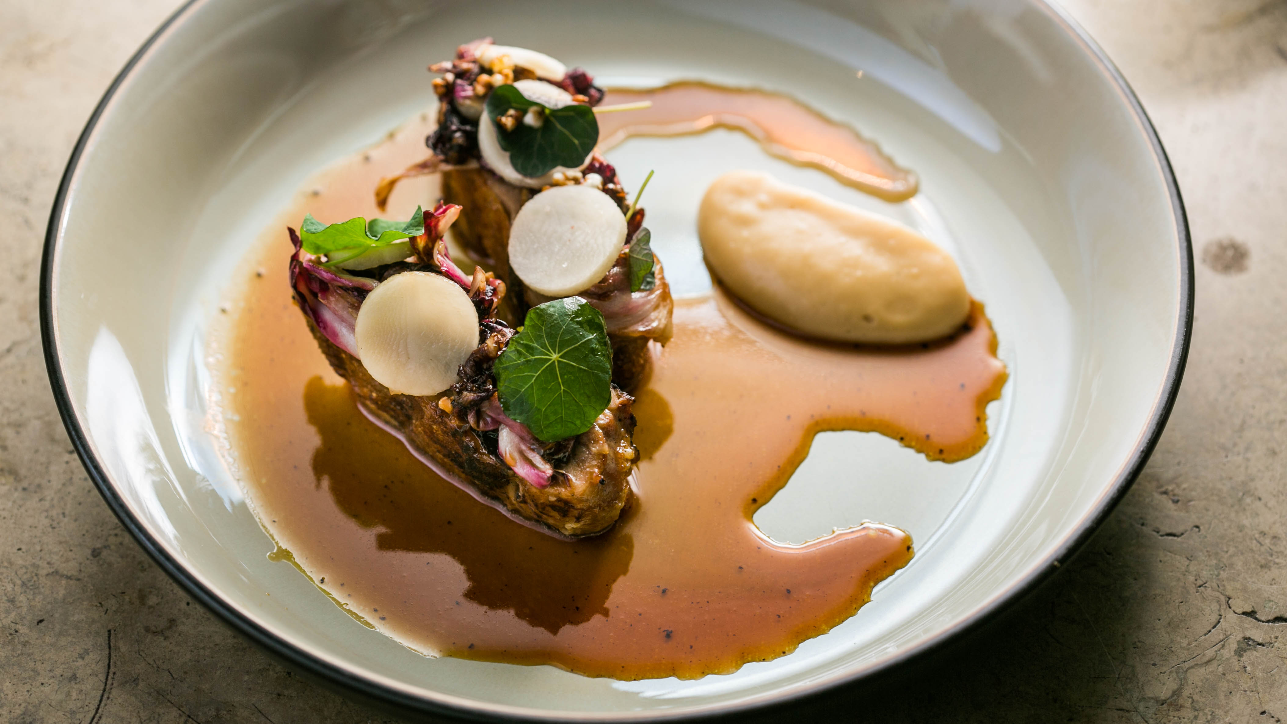 Roasted guinea fowl with buckwheat miso, Jerusalem artichoke cream, and radicchio from ORE.