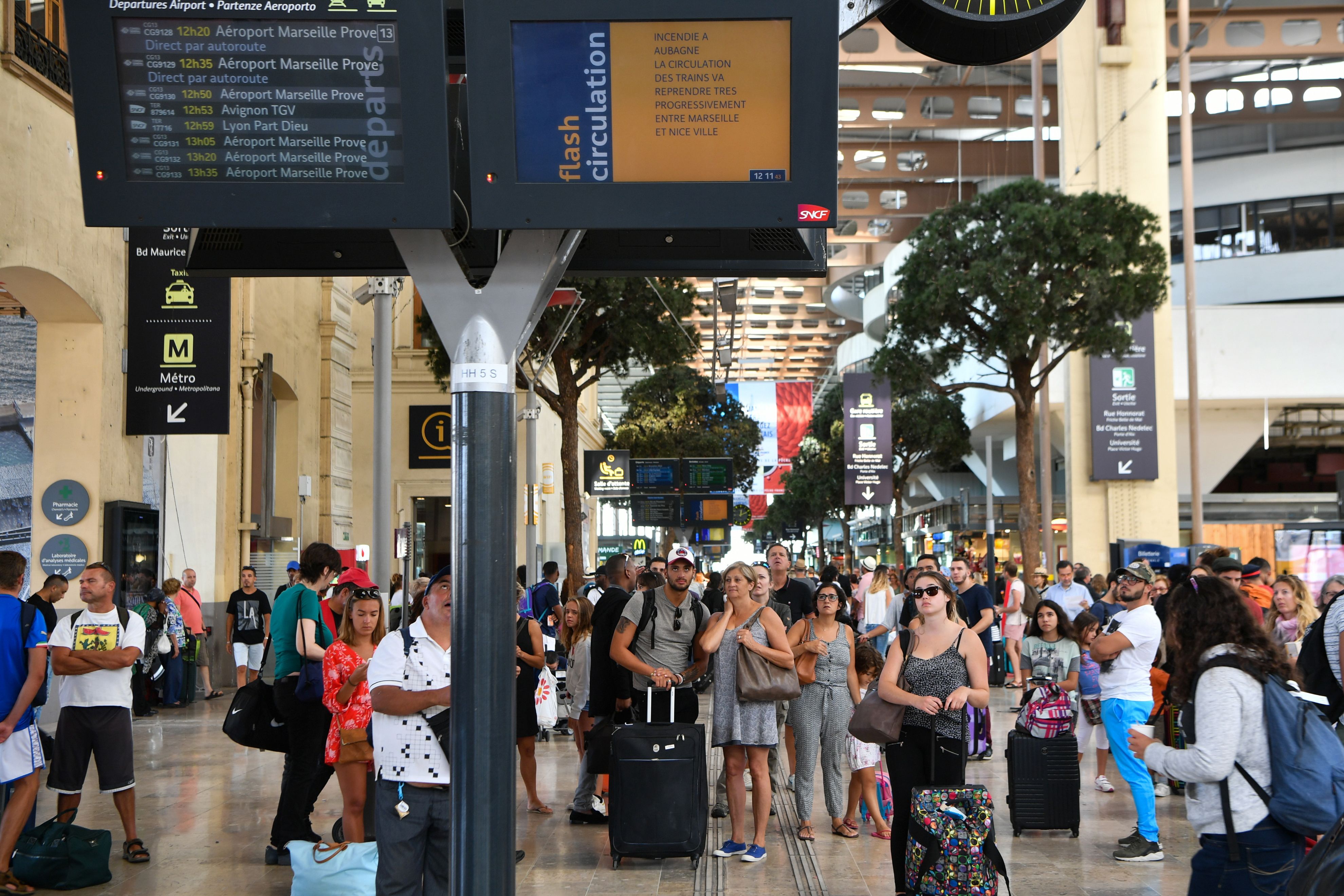 Passengers looked at information monitors as they waited for their trains at Saint Charles Station in Marseille.
