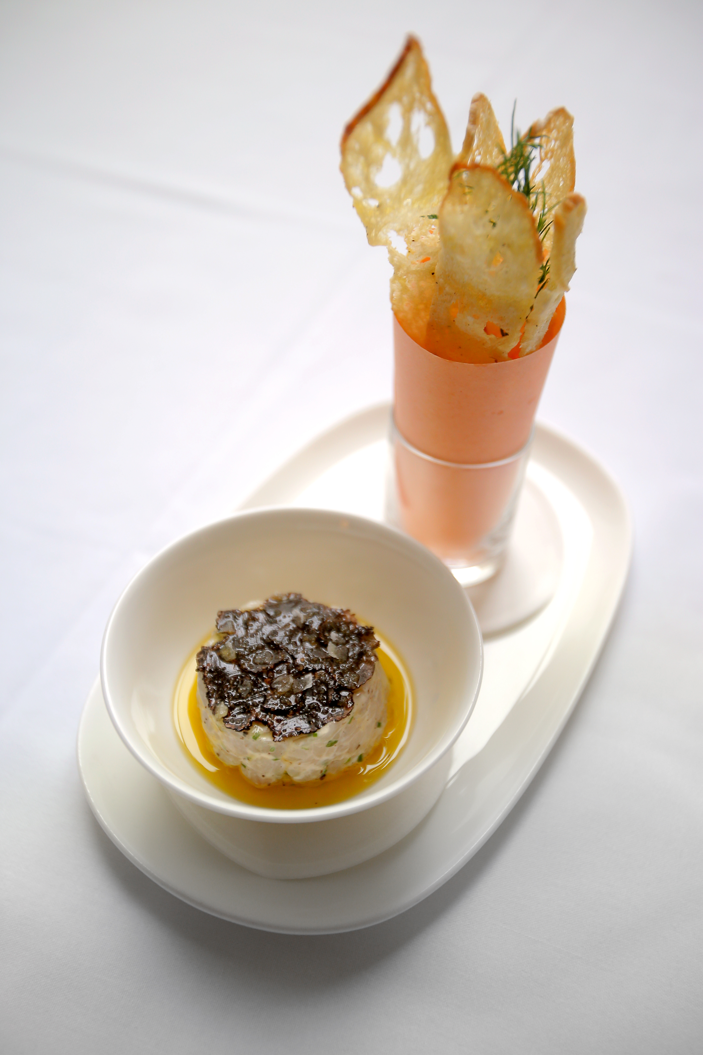 Sea bass tartare with shavings of black truffle and fennel crostini on the side.