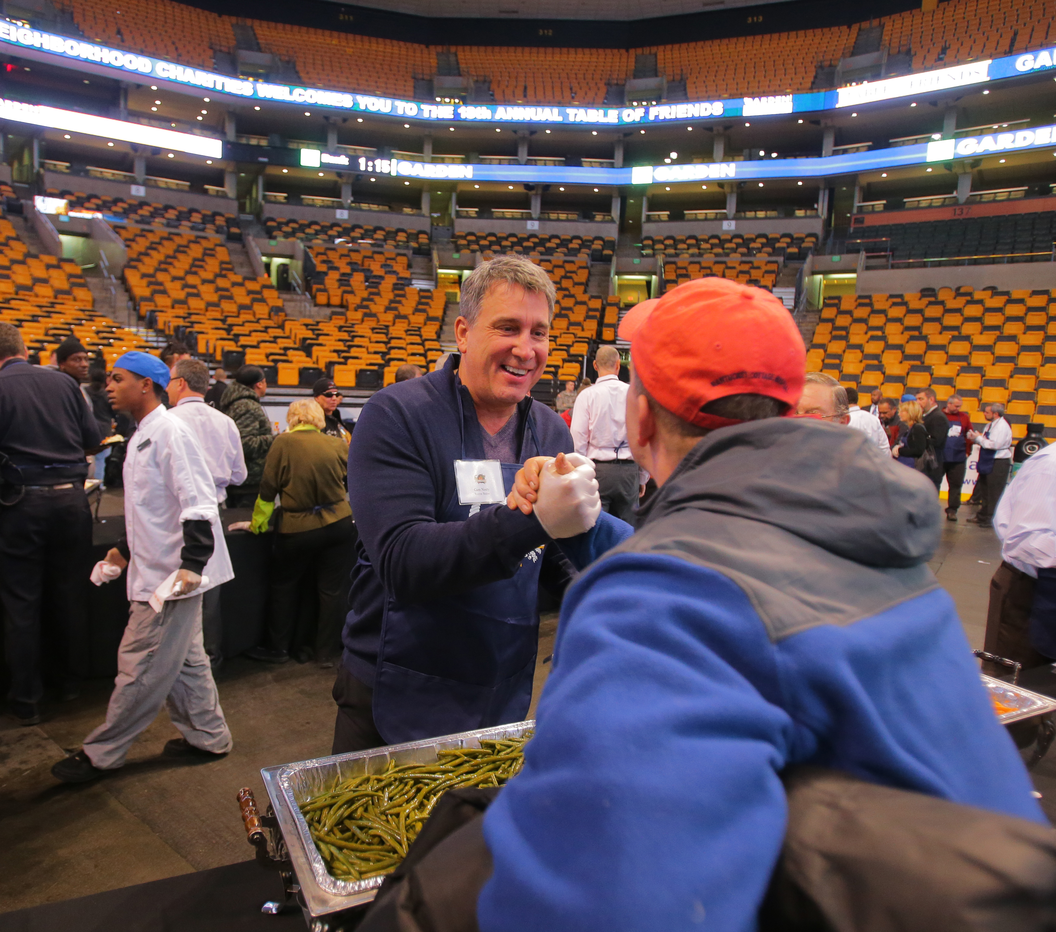 A spokesman for TD Garden said it already raises $2 million a year through its philanthropies. Here, Bruin legend Cam Neely shook hands with Chuck Suess at an event for the Garden Neighborhood Charities.
