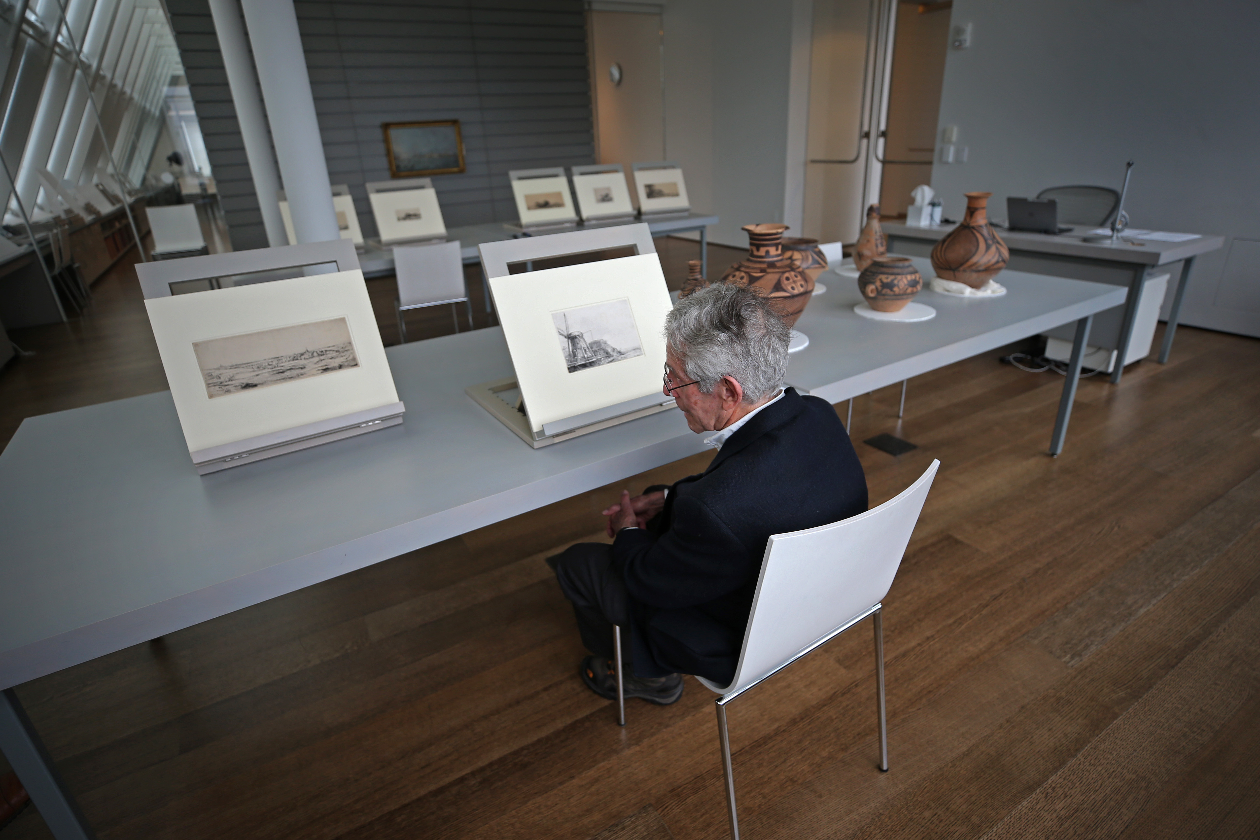 Westlund looked over some Dutch landscape etchings by Rembrandt.