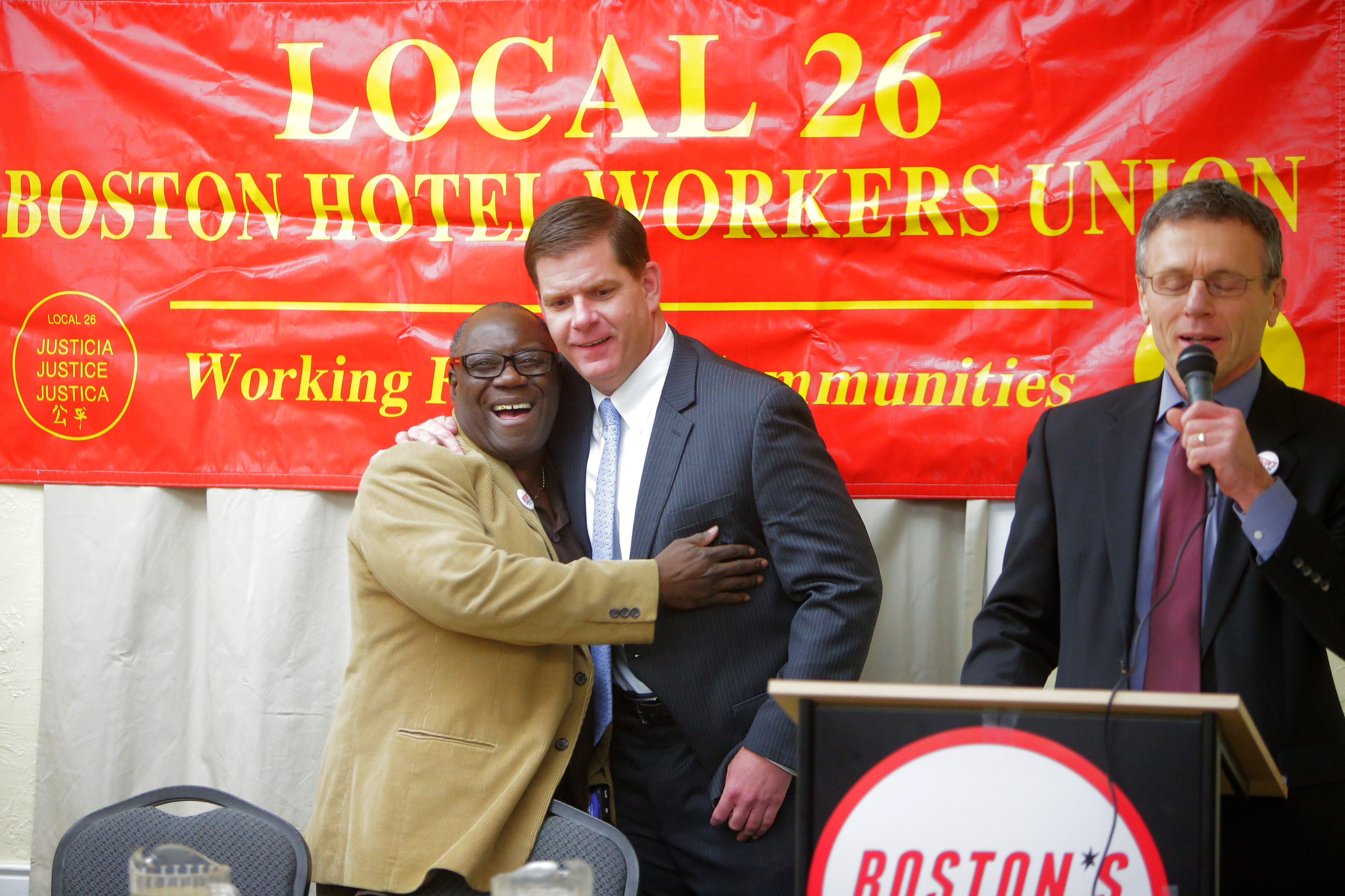 Local 26’s Financial Secretary Treasurer Henry C. Green embraced Mayor Martin J. Walsh while union president Brian Lang addressed the crowd at a union meeting in 2014.