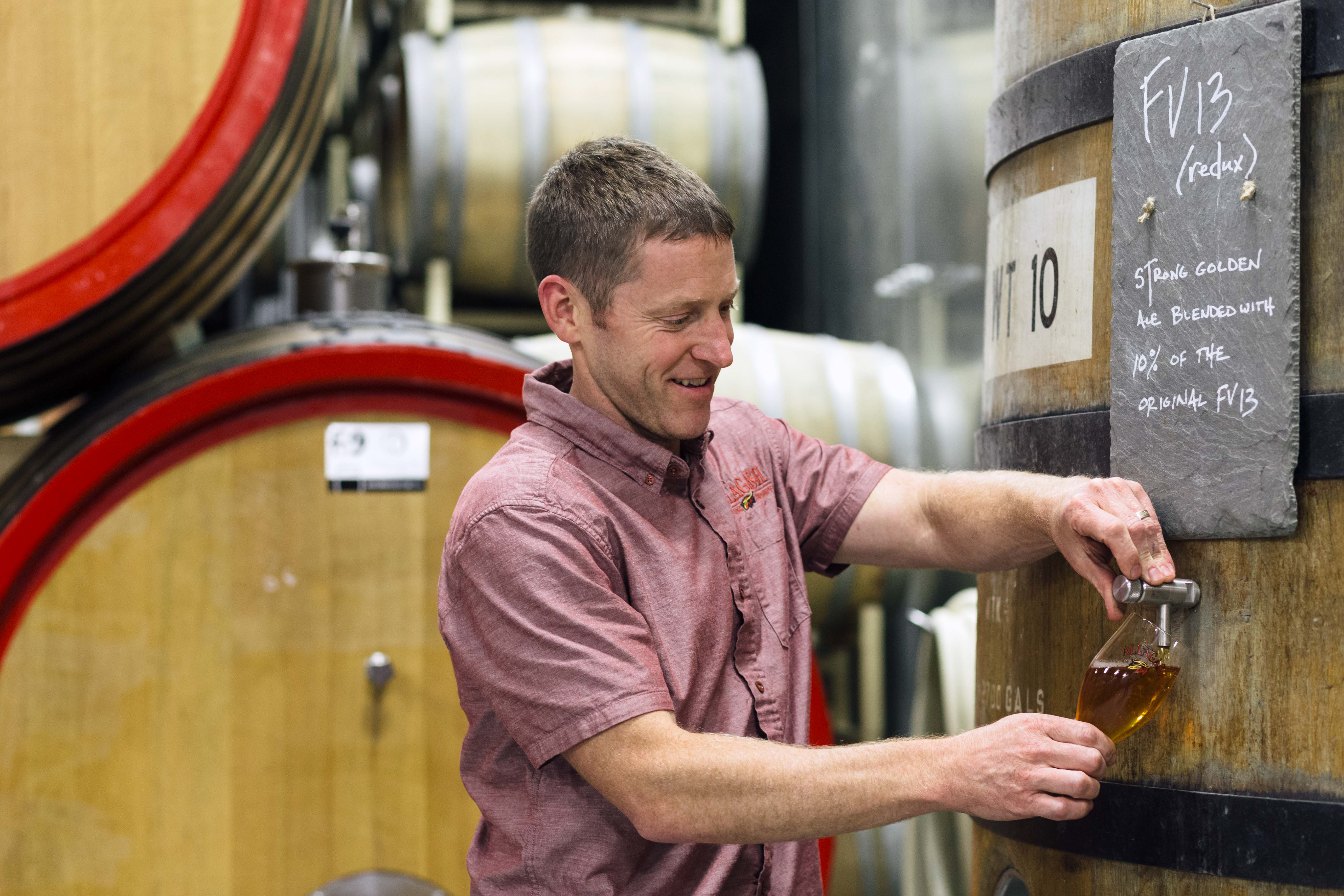 Brewmaster Jason Perkins hard at work with barrel-aged Belgian-style golden ale at Allagash Brewing Company.