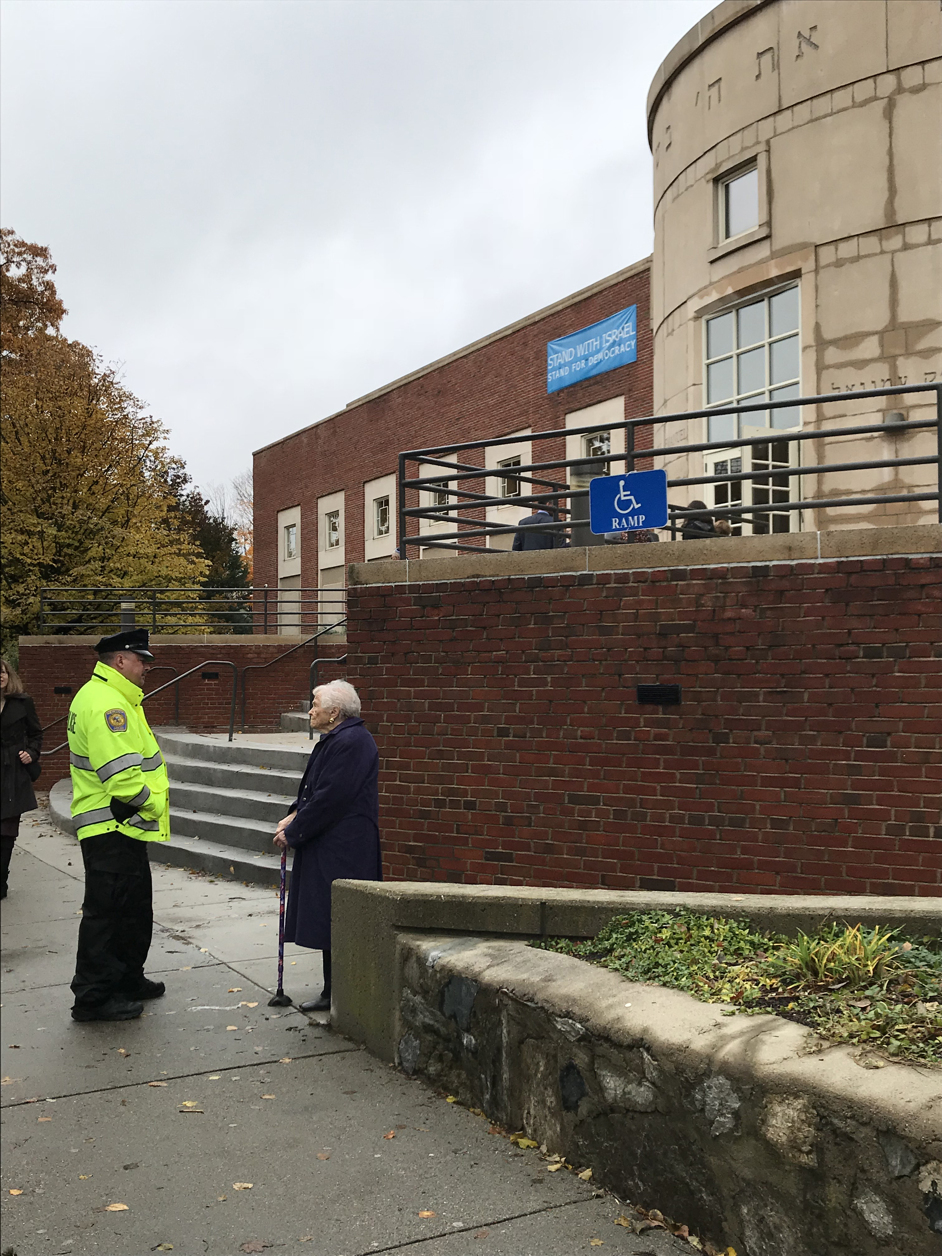 A woman spoke with a police officer outside Temple Emanuel in Newton on Saturday.