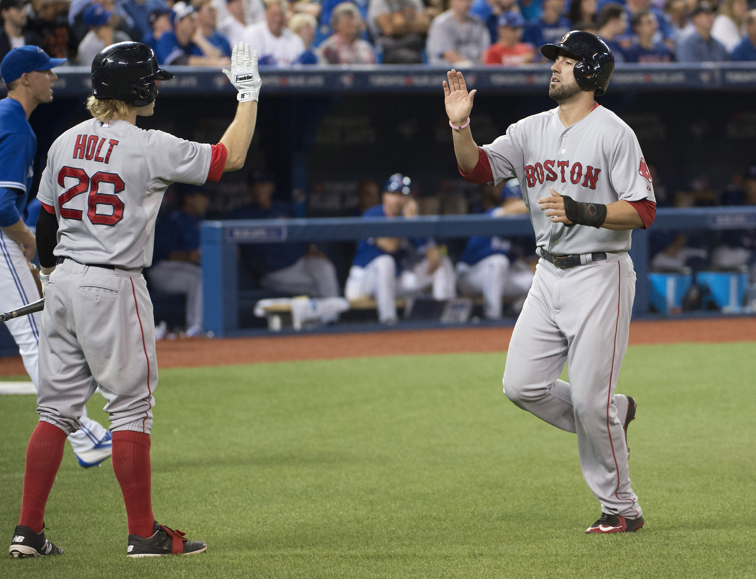 Brock Holt (left) and Travis Shaw high-fived after a ninth-inning run.