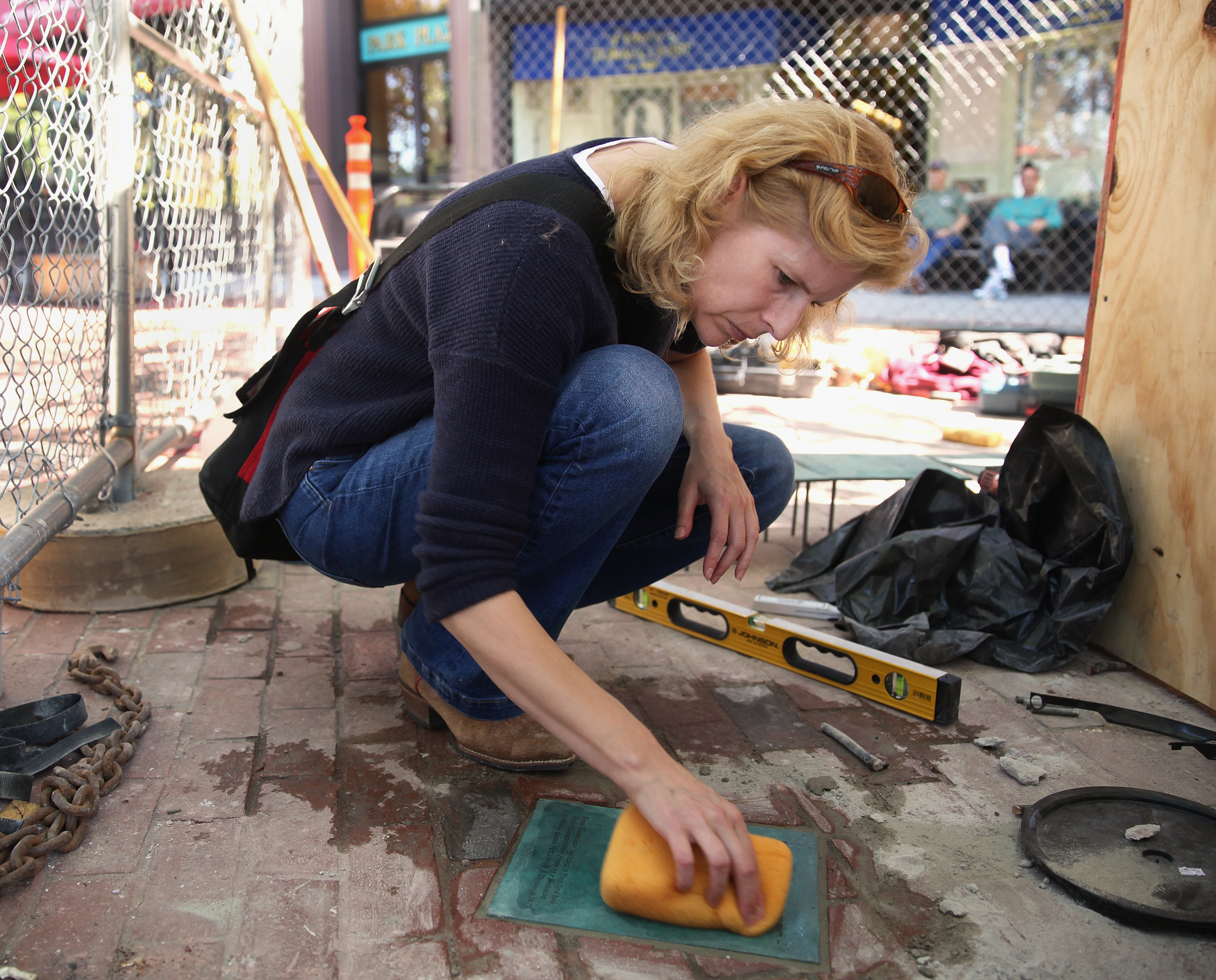 Stefanie Rocknak cleans off a manuscript page, one of a trail of pages that are part of her sculpture of Edgar Allan Poe to be dedicated Oct. 4-5 across from Boston Common.