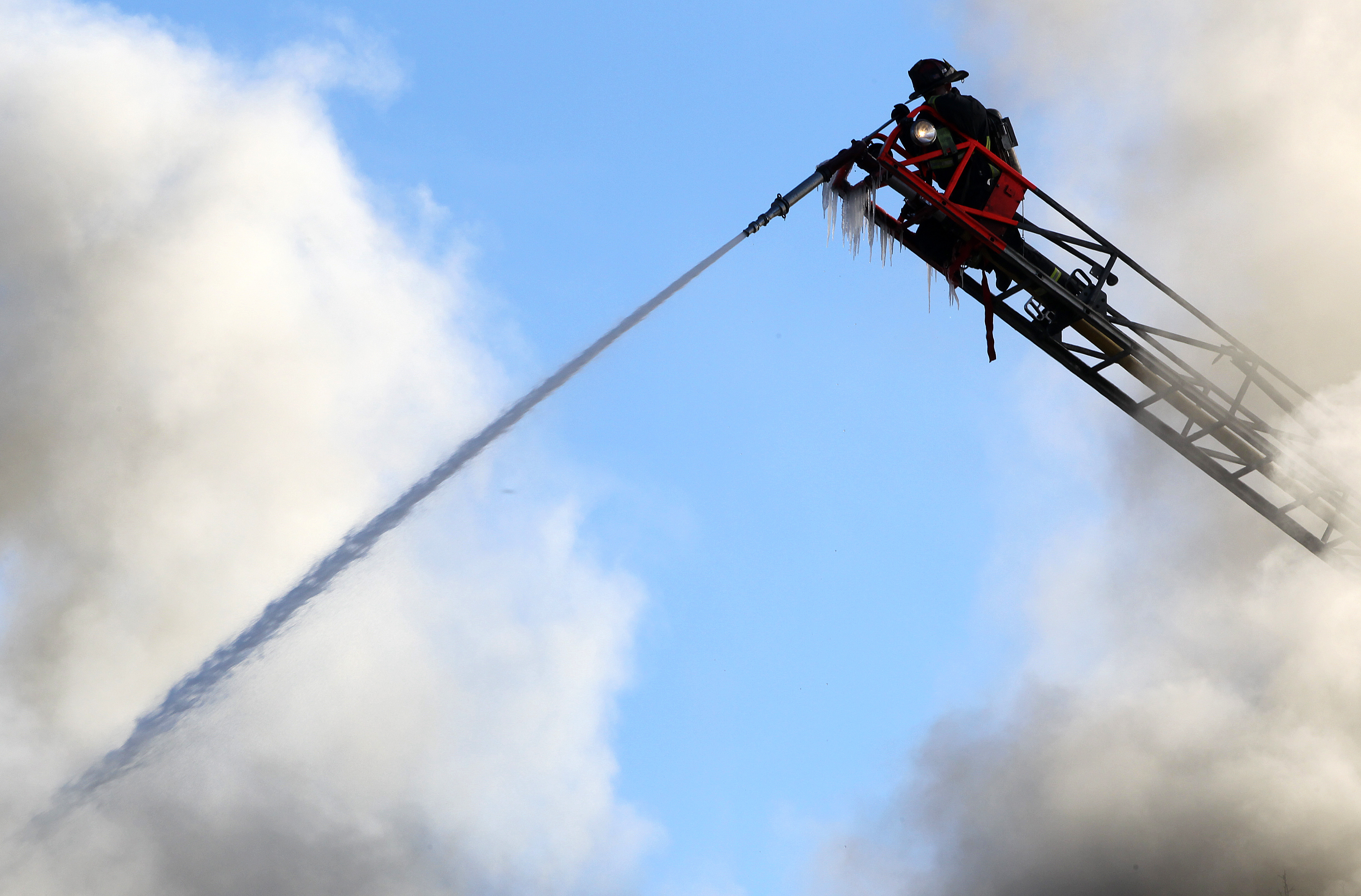 Firefighters faced freezing temperatures, high winds, and acrid smoke as they battled a fire for more than seven hours in Brighton yesterday.