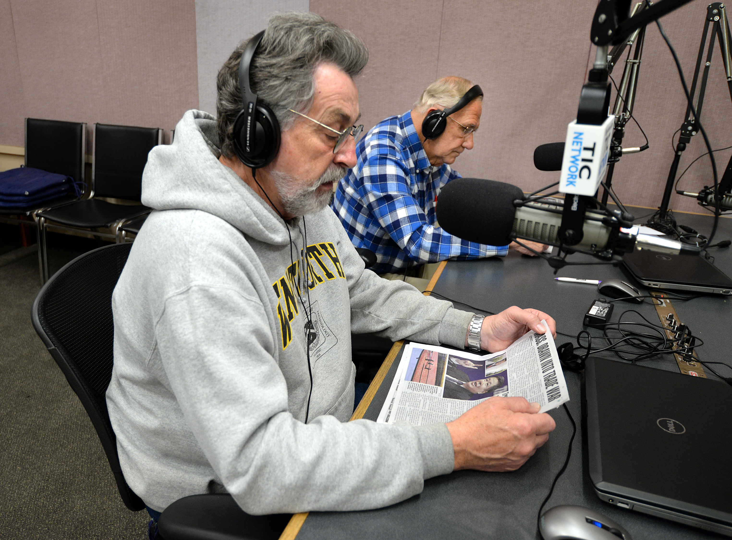 Haskell and Robinson read the news at the microphones of the Talking Information Center . . .