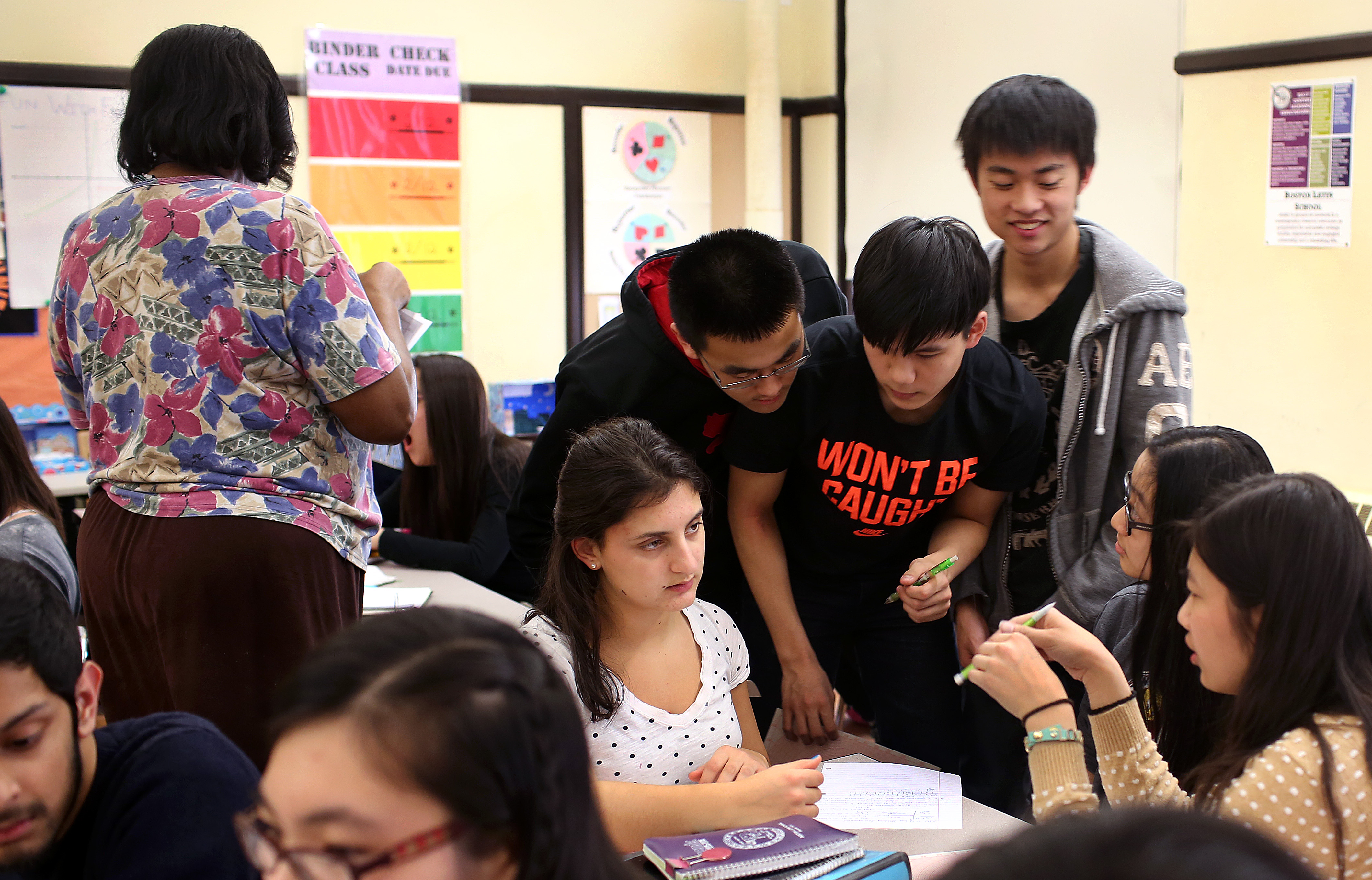 Students gathered to work on a problem in an 11th-grade advanced pre-calculus class.