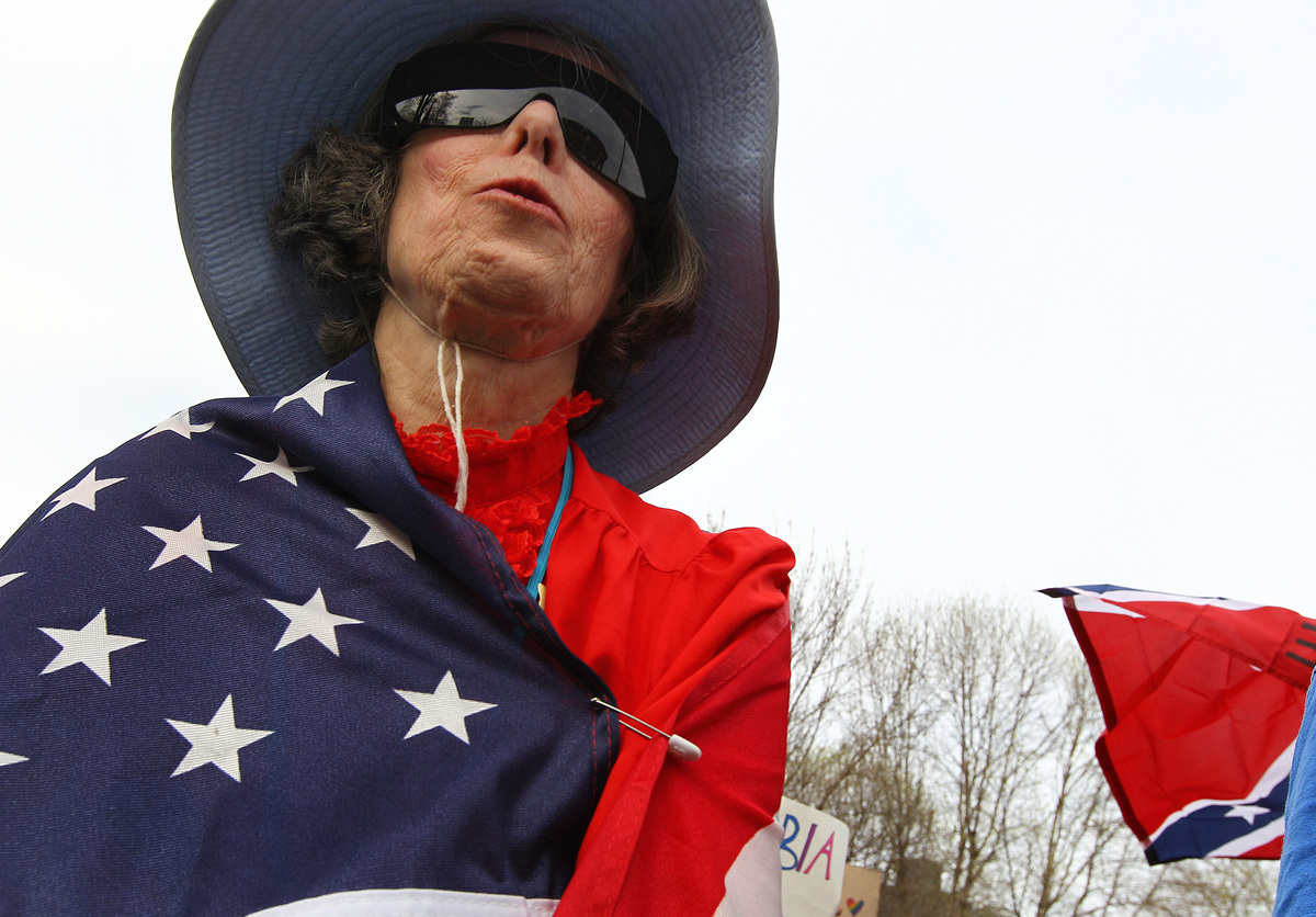 Christina Gordon of Watertown wrapped herself in a flag while attending the Mass Tea Party’s Patriots Day Rally in Boston.