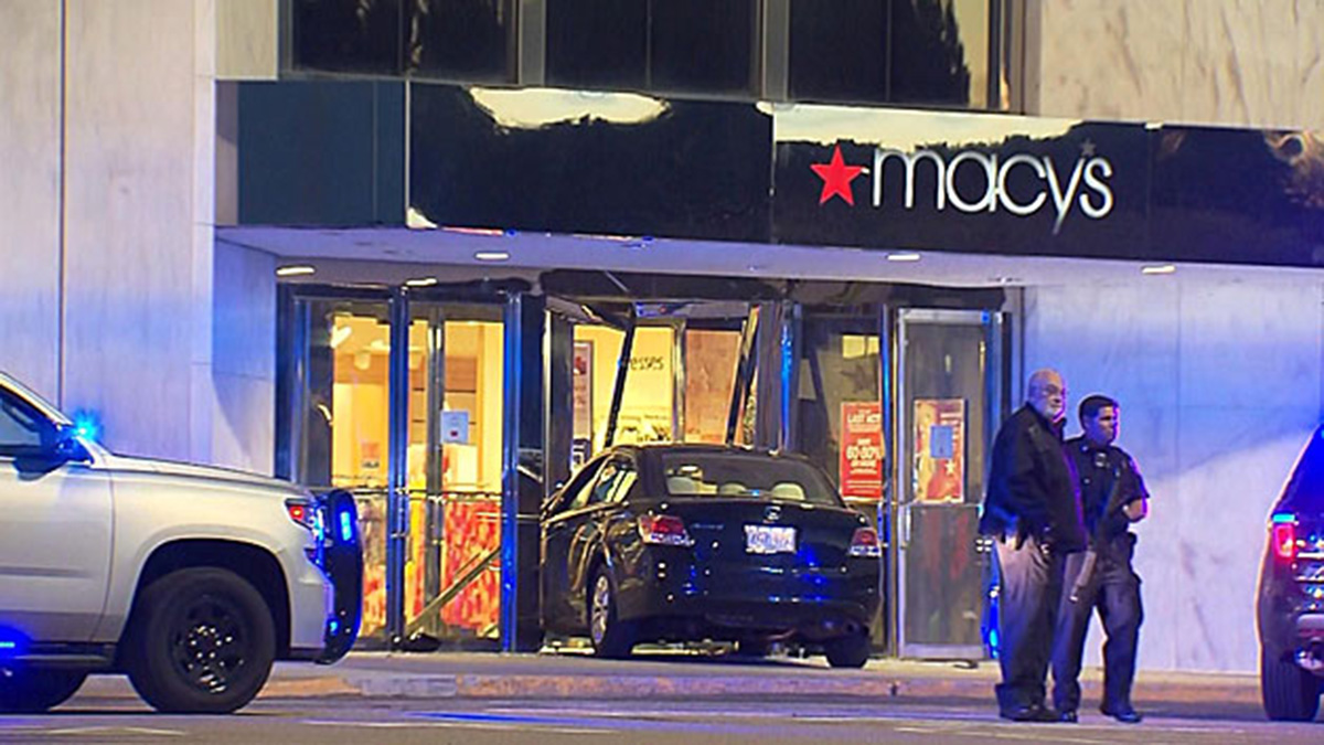 The suspect crashed his car into the entrance of a Macy’s after stabbing two women at a home nearby, authorities said.
