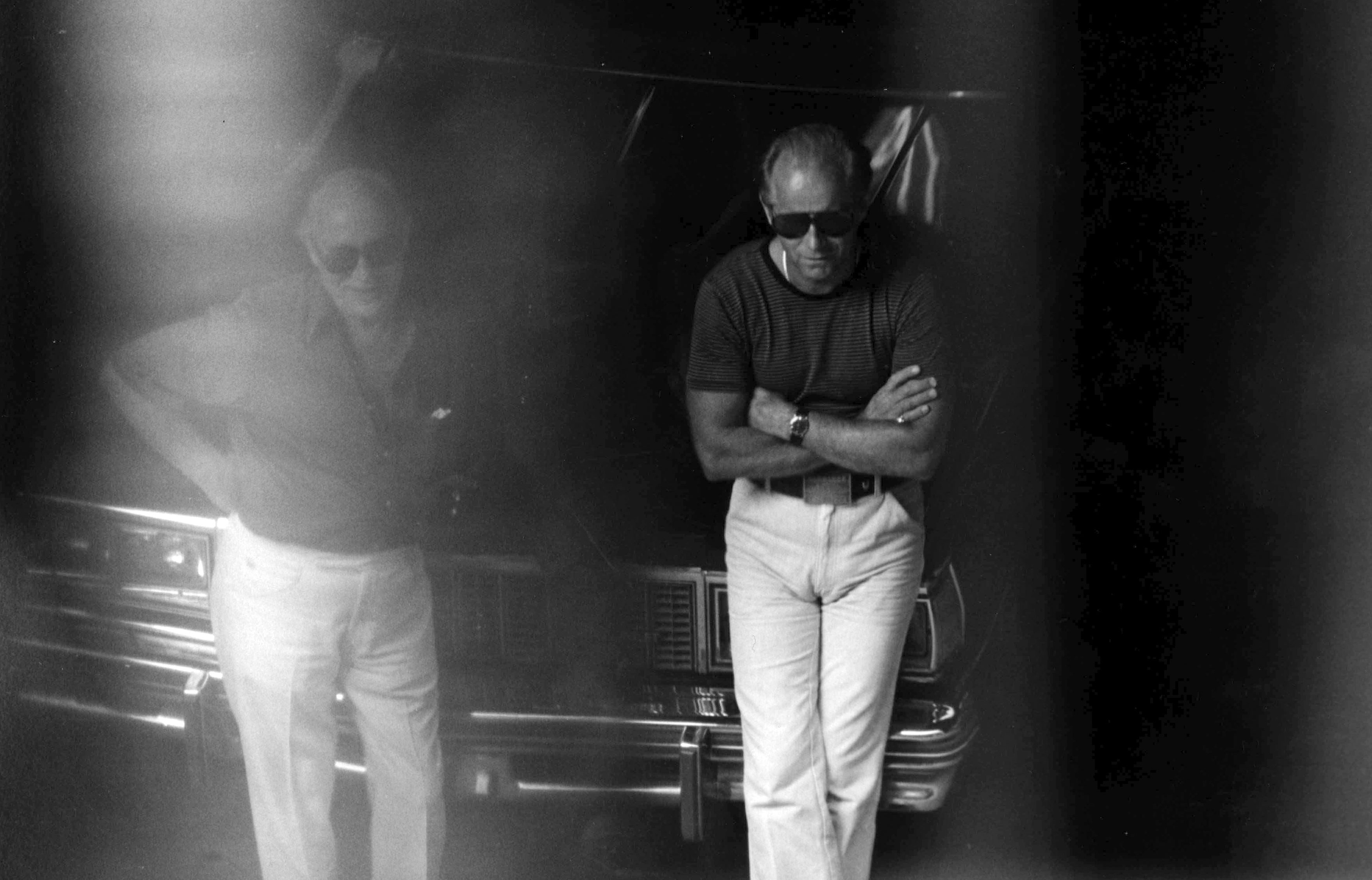 A 1980 surveillance photo shows James "Whitey" Bulger, right, and another man at a Lancaster Street garage in Boston's North End.