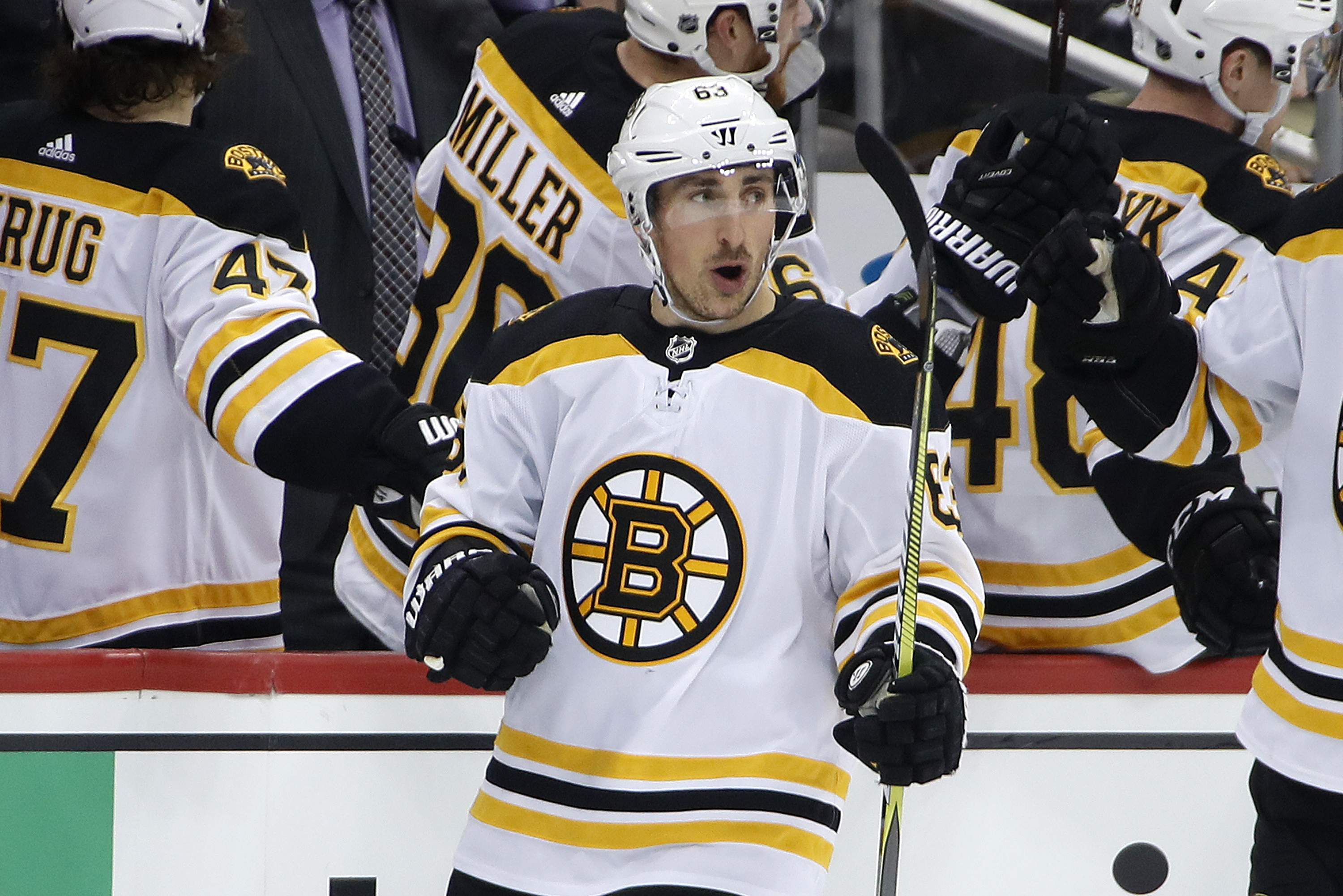 Brad Marchand returns to the bench after pulling the Bruins to within 3-2 in the second period, assisted by Patrice Bergeron.