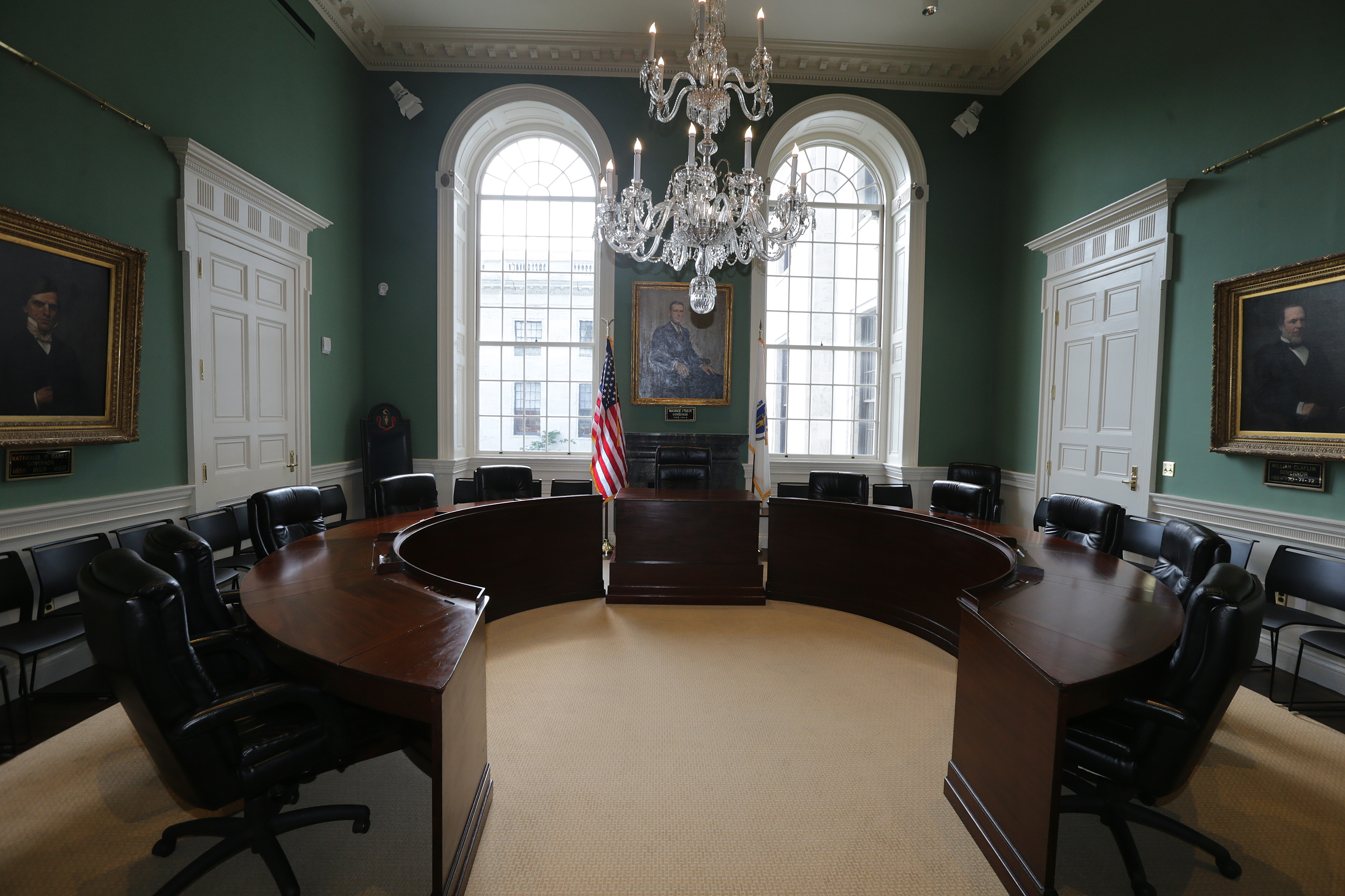 A 19th-century curved wooden desk rescued from a farmhouse in Lancaster centers the governor’s council chamber.