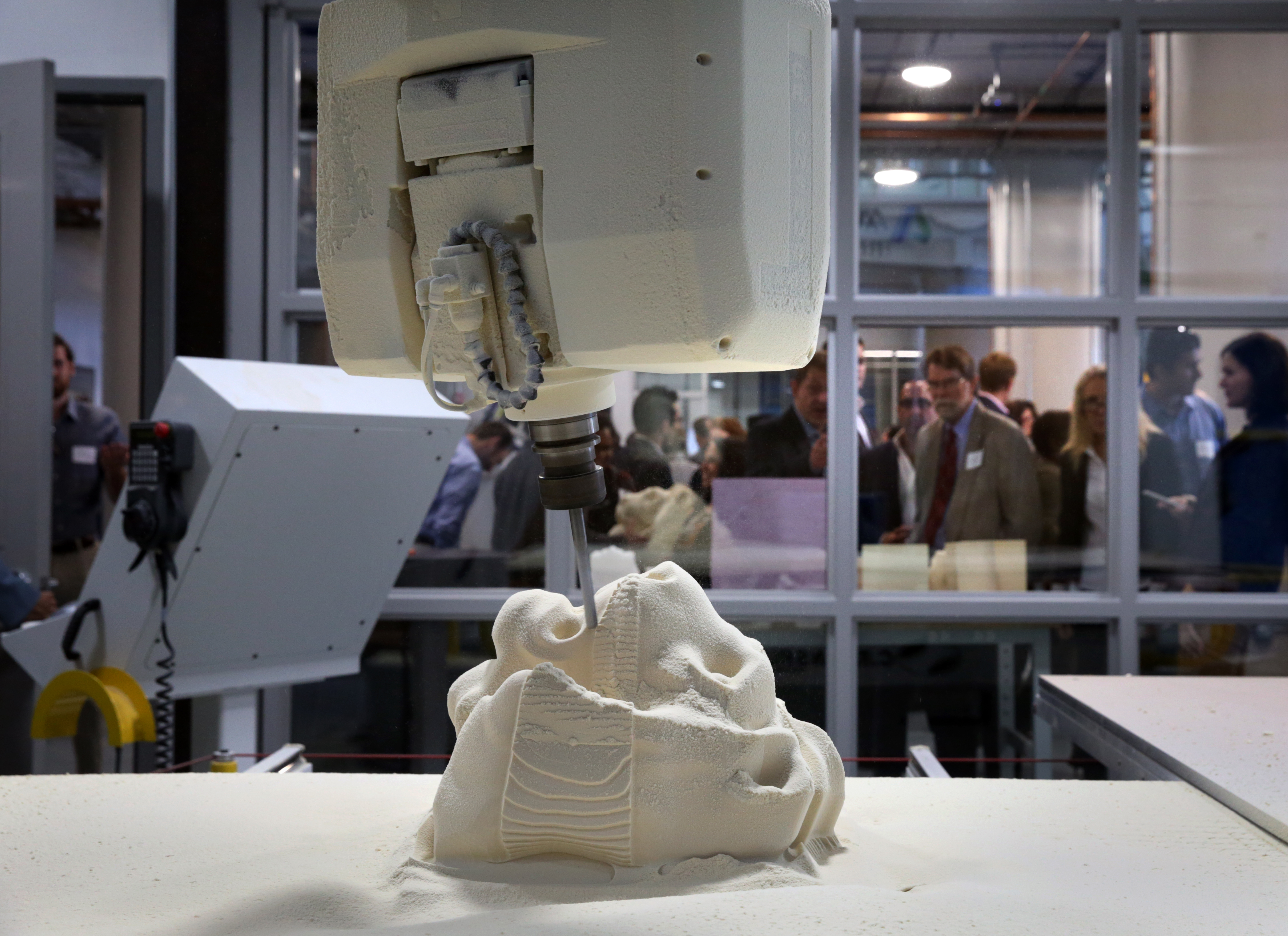 A router is used to recreate a lion head sculpture at the facility.