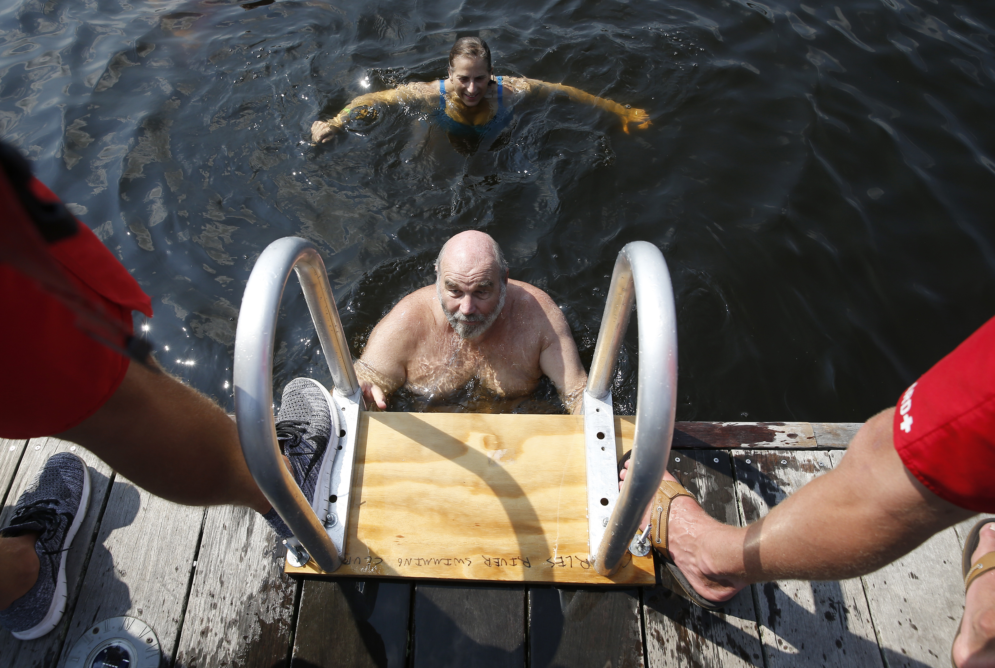 Lifeguards kept a foot on the dock ladder to make sure it remained secure.