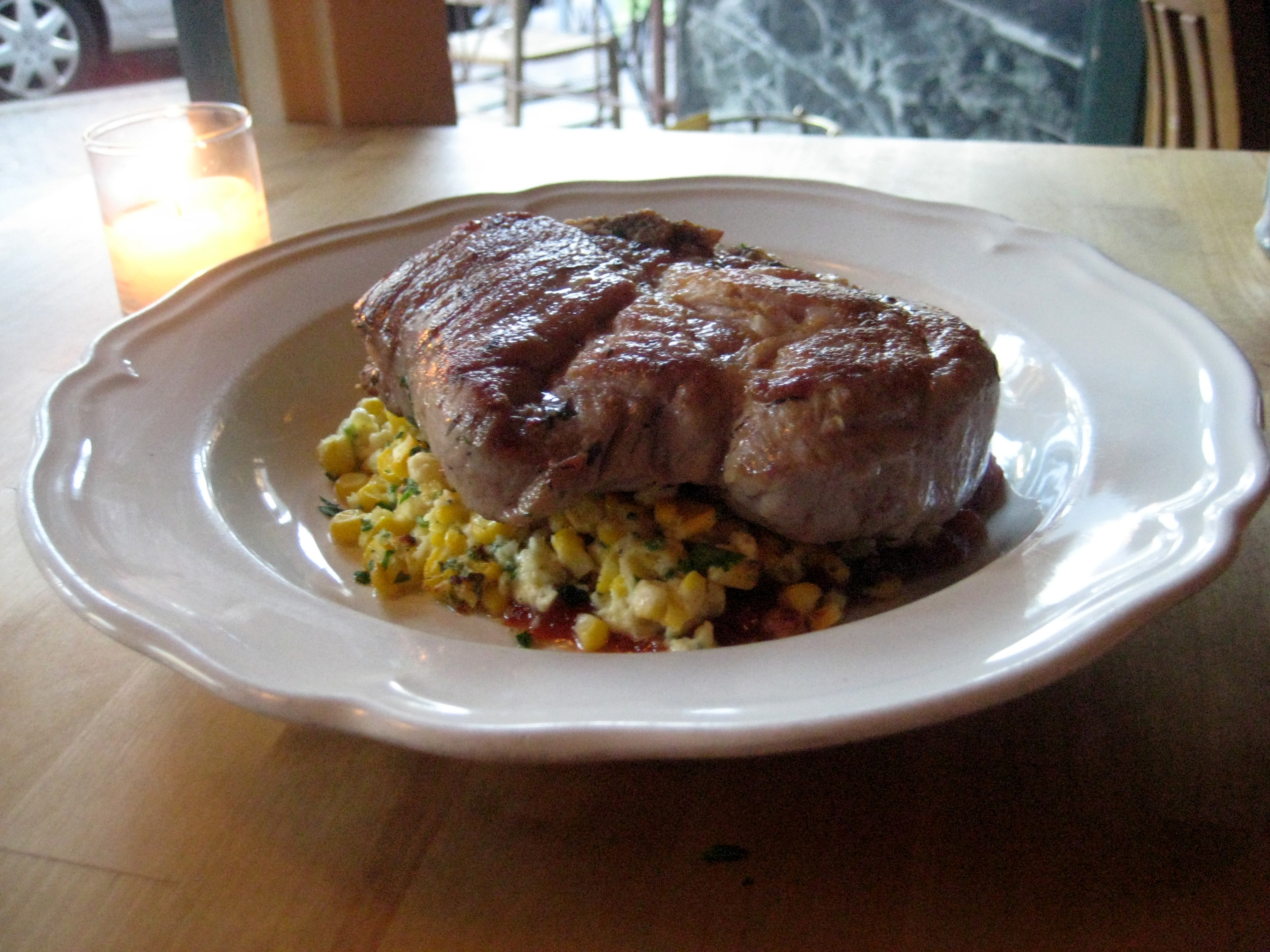 Pork chop with corn pudding and tomato jam.