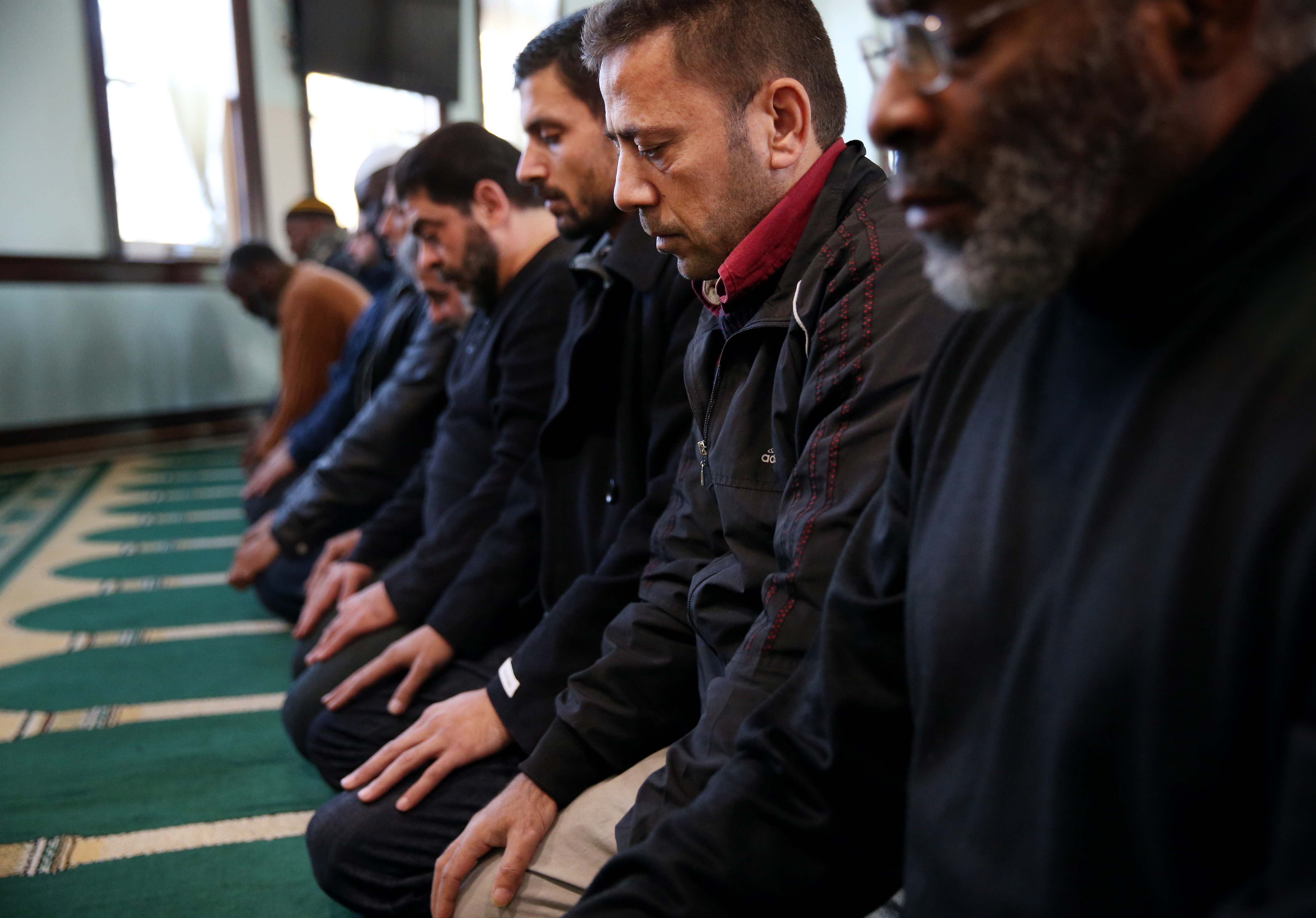 Syrian refugees Mohamad Shami (second right) and Mahmoud Al Nayef (third right) took part in prayer services at the Islamic Society of Greater Worcester.