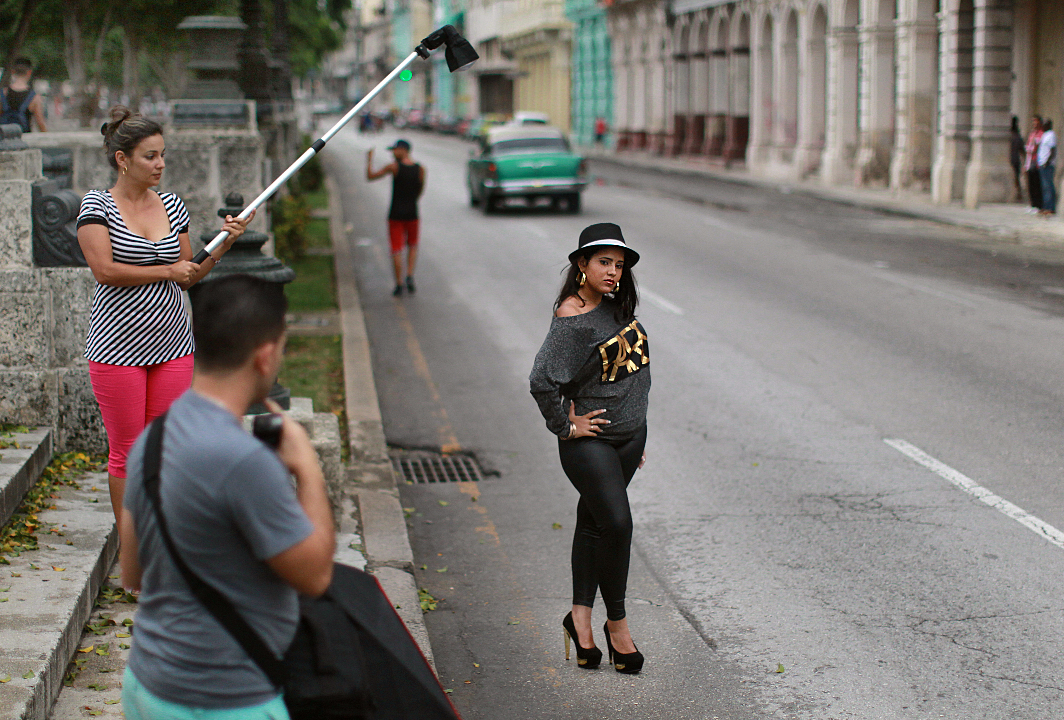 Diana Ramirez poses in the middle of the Prado to have photographs taken for her quinceañera.