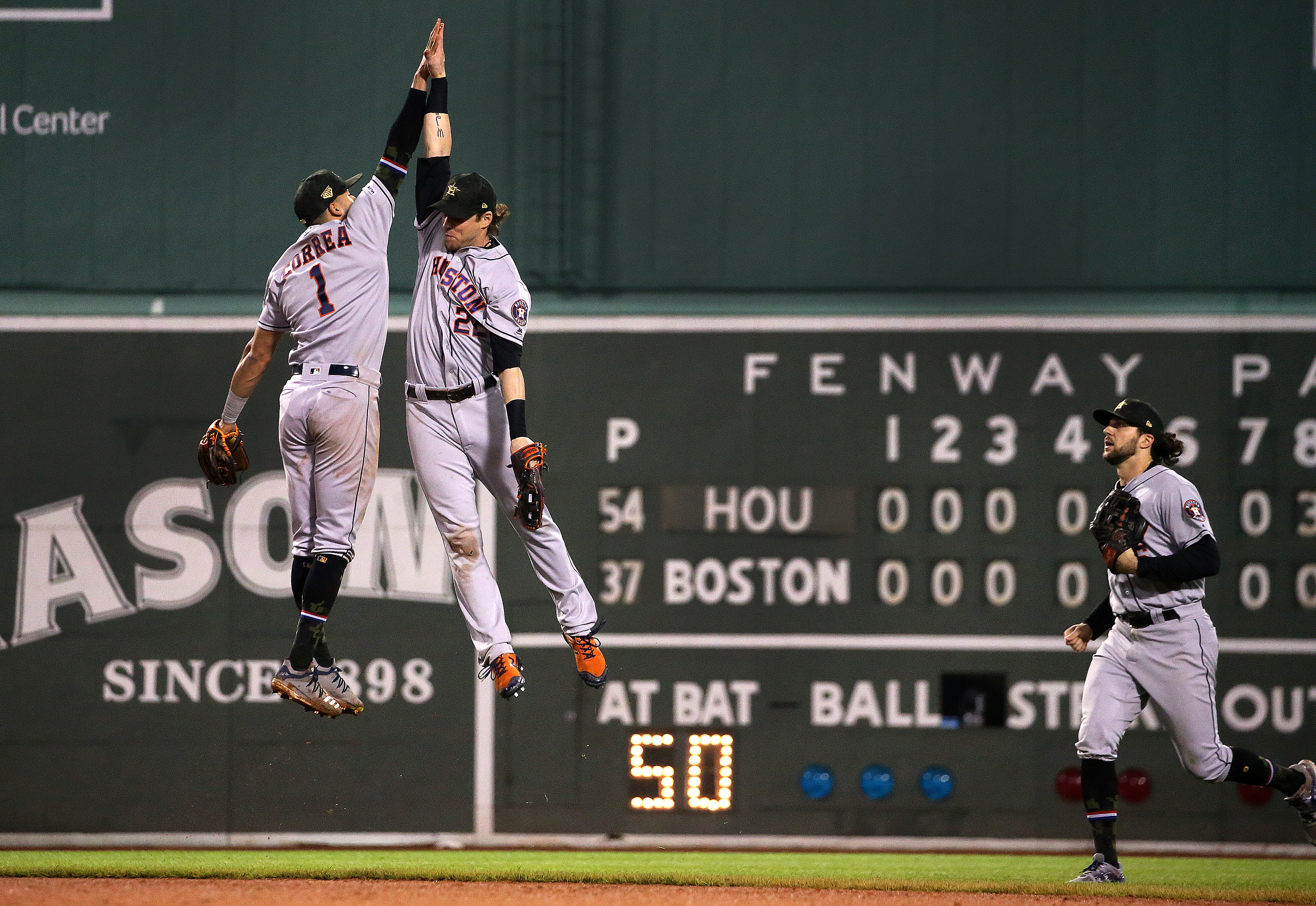 Carlos Correa (1) and Josh Reddick celebrate Houston’s series-opening win on Friday.