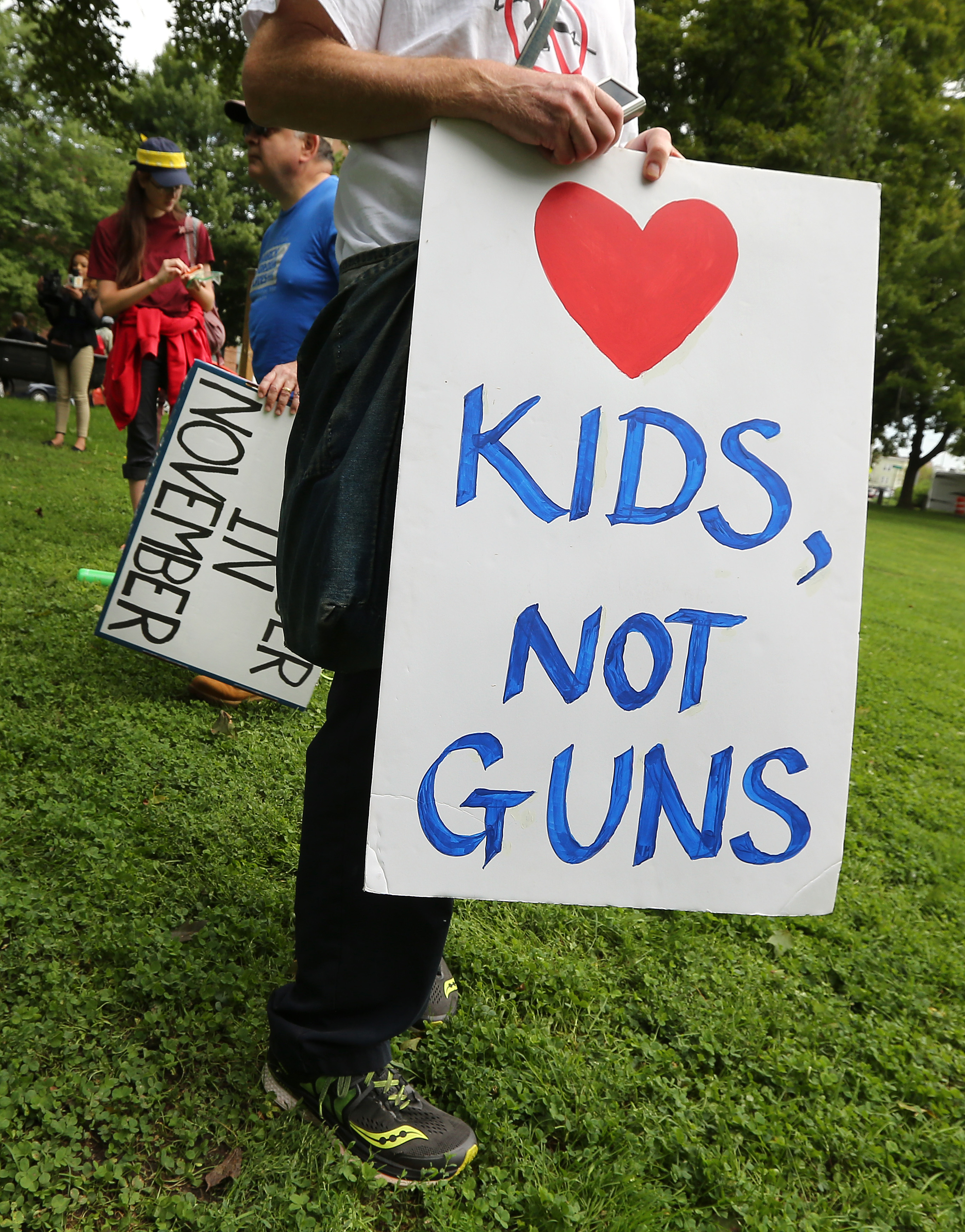 Some adults held signs at the group's first 1.5-mile rest stop, at University Park.