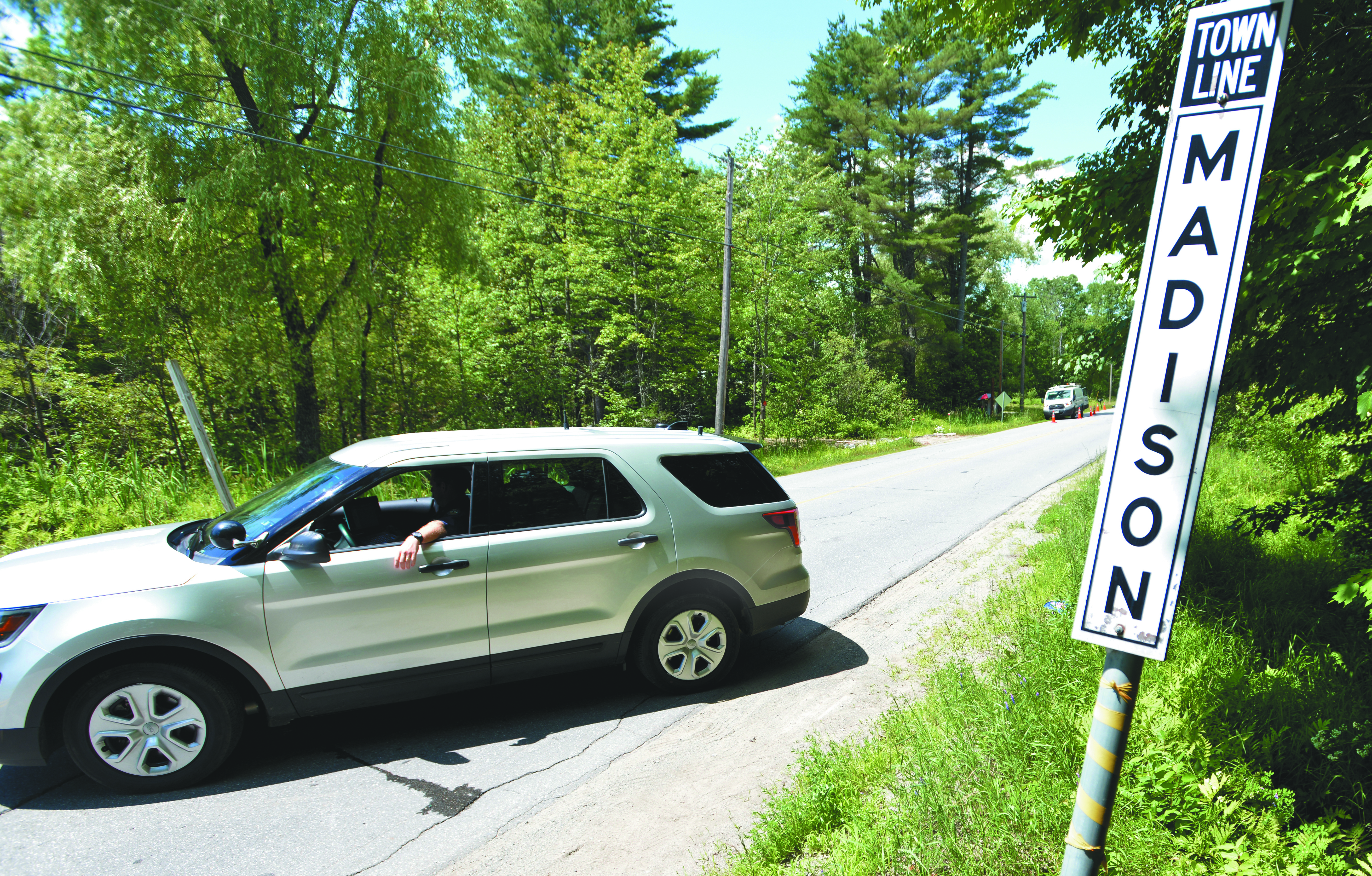 Trooper Parker with the Maine State Police turned vehicles around on Russell Road at the town line of Skowhegan and Madison as investigators work on the scene with multiple murder victims.