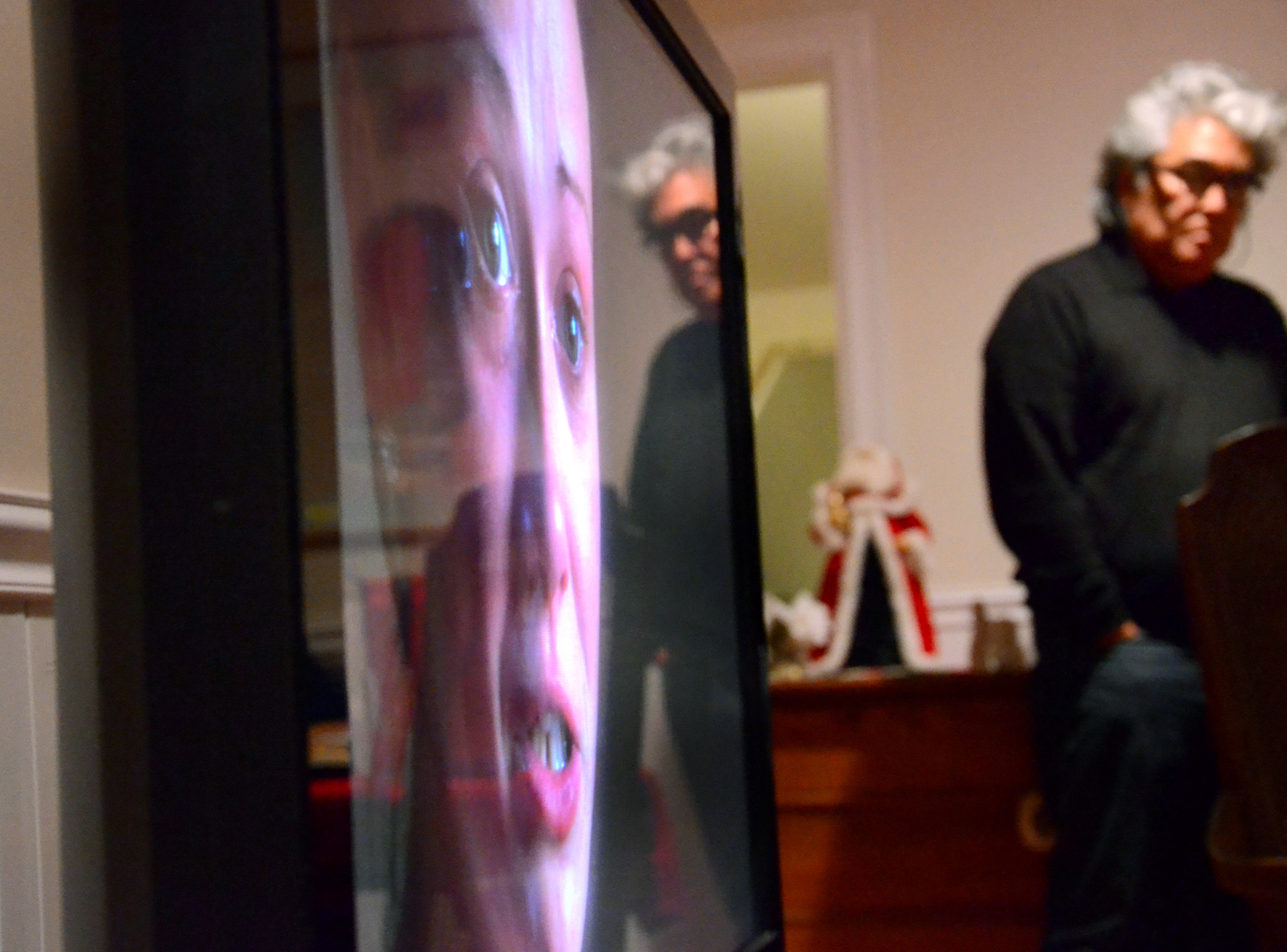 Steve Okazaki, who directed the documentary, reflected in the TV as his film is shown to the Parents Supporting Parents Group of Cape Cod in Bourne.