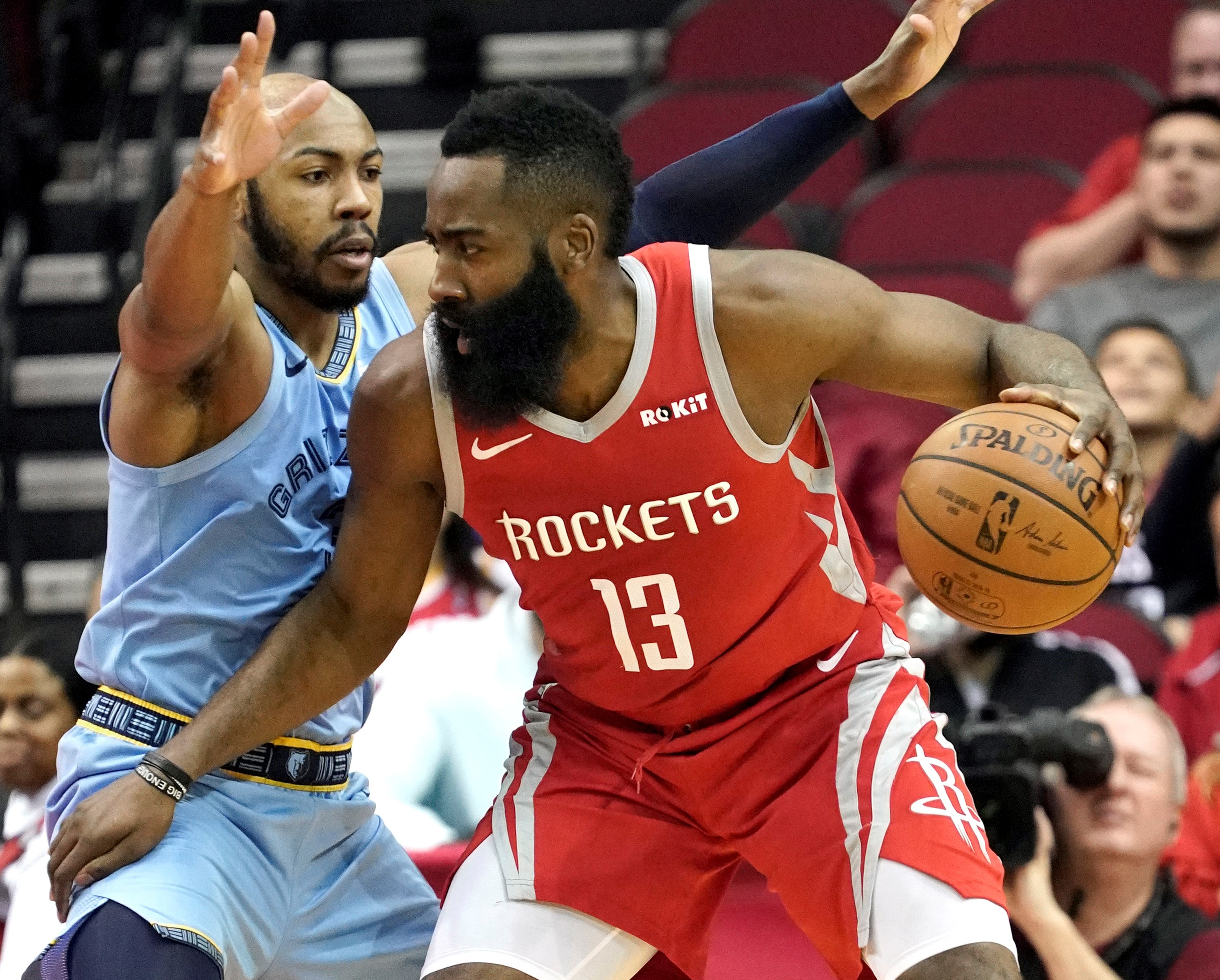 The Grizzlies’ Jevon Carter (left) defends against James Harden during the first half Monday.