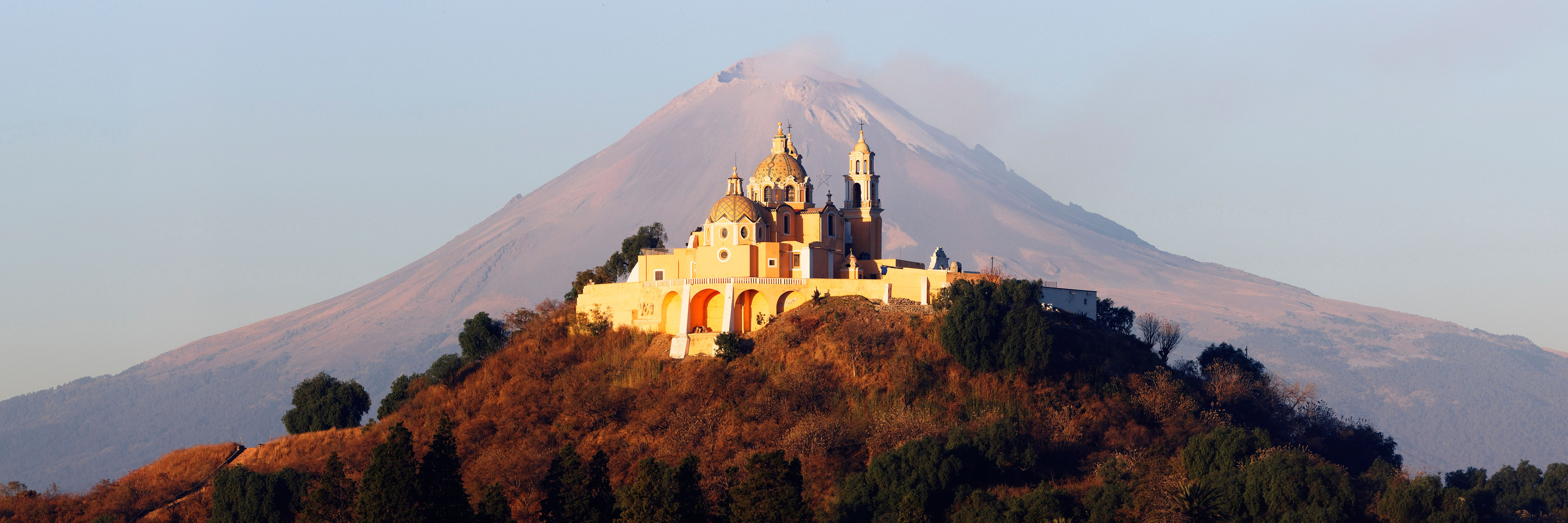 Framed by a volcano, the 16th-century Iglesia de Nuestra Señora de los Remedios sits atop the Tlachihualtepetl pyramid 30 miles outside of Puebla.