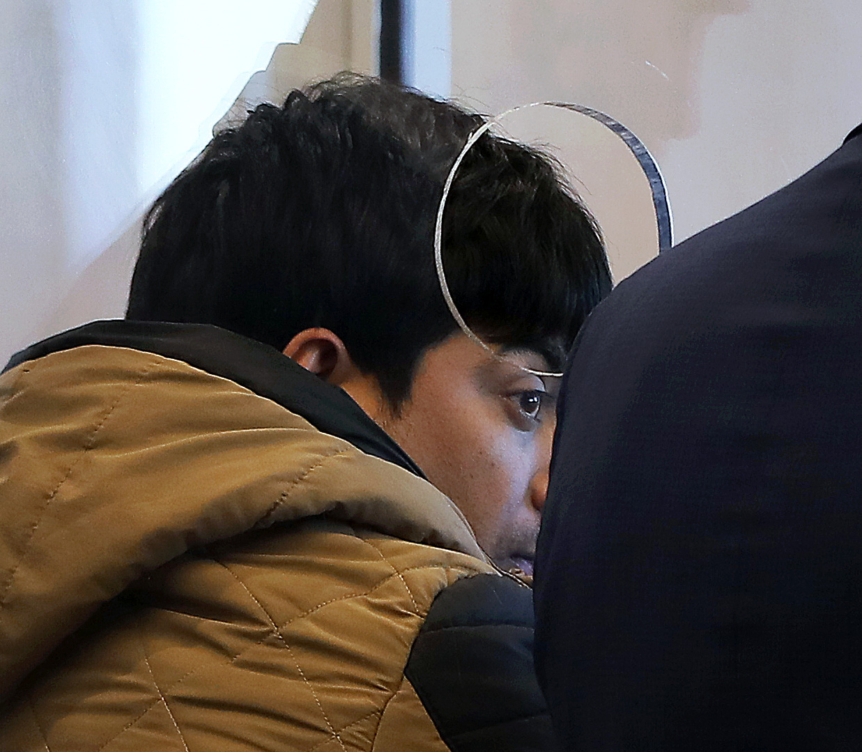 Ranjan Thapa, 26, of Everett, watched his arraignment from the prisoner’s dock in Roxbury Municipal Court. An Uber driver, he is accused of raping an intoxicated female passenger during the weekend; a not-guilty plea was entered.