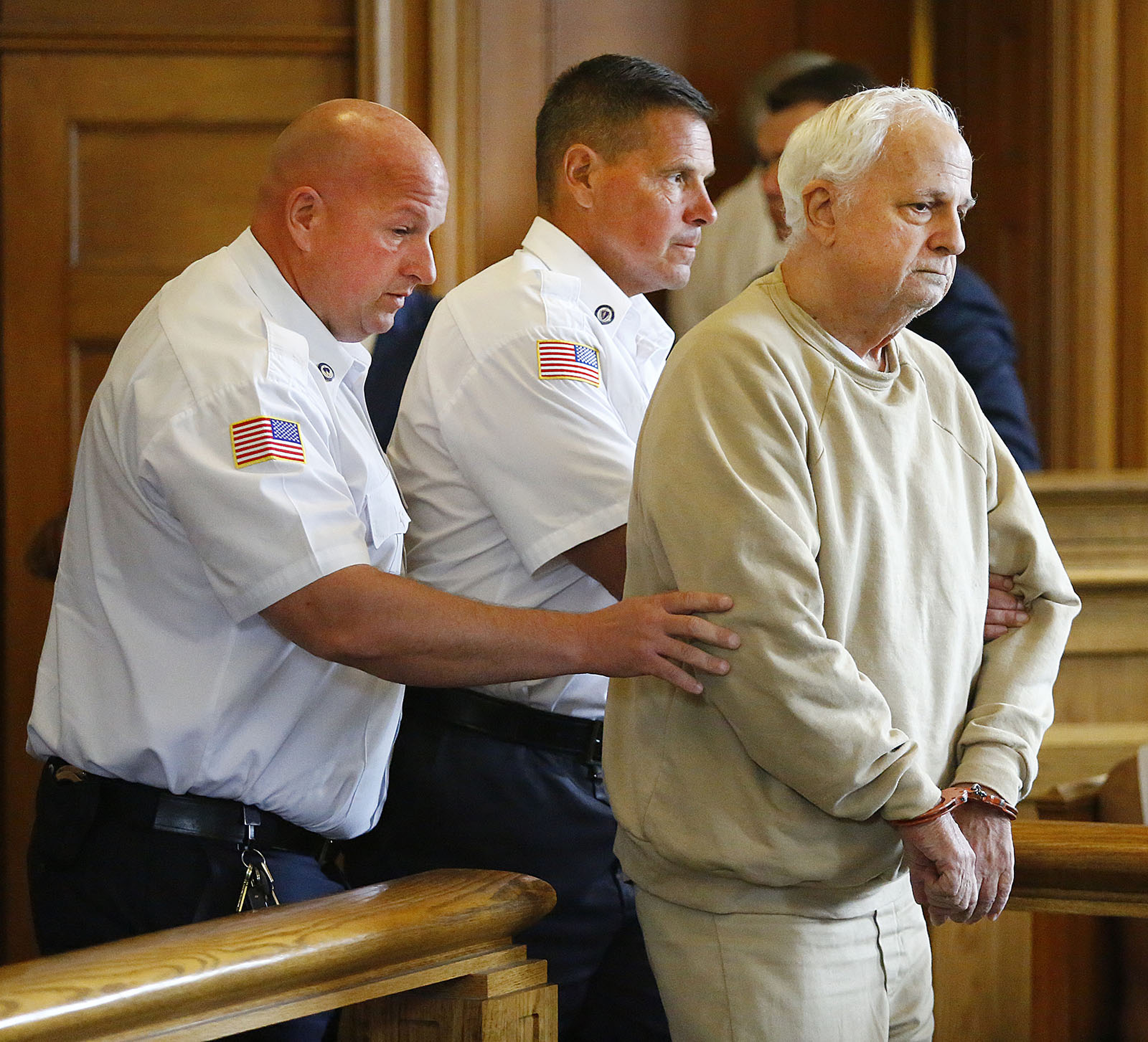 Former Milton Academy theater program director Reynold Buono, 72, appeared in Dedham Superior Court on Wednesday. Buono pleaded not guilty to three counts of rape of a child and three counts of rape of a child with force.