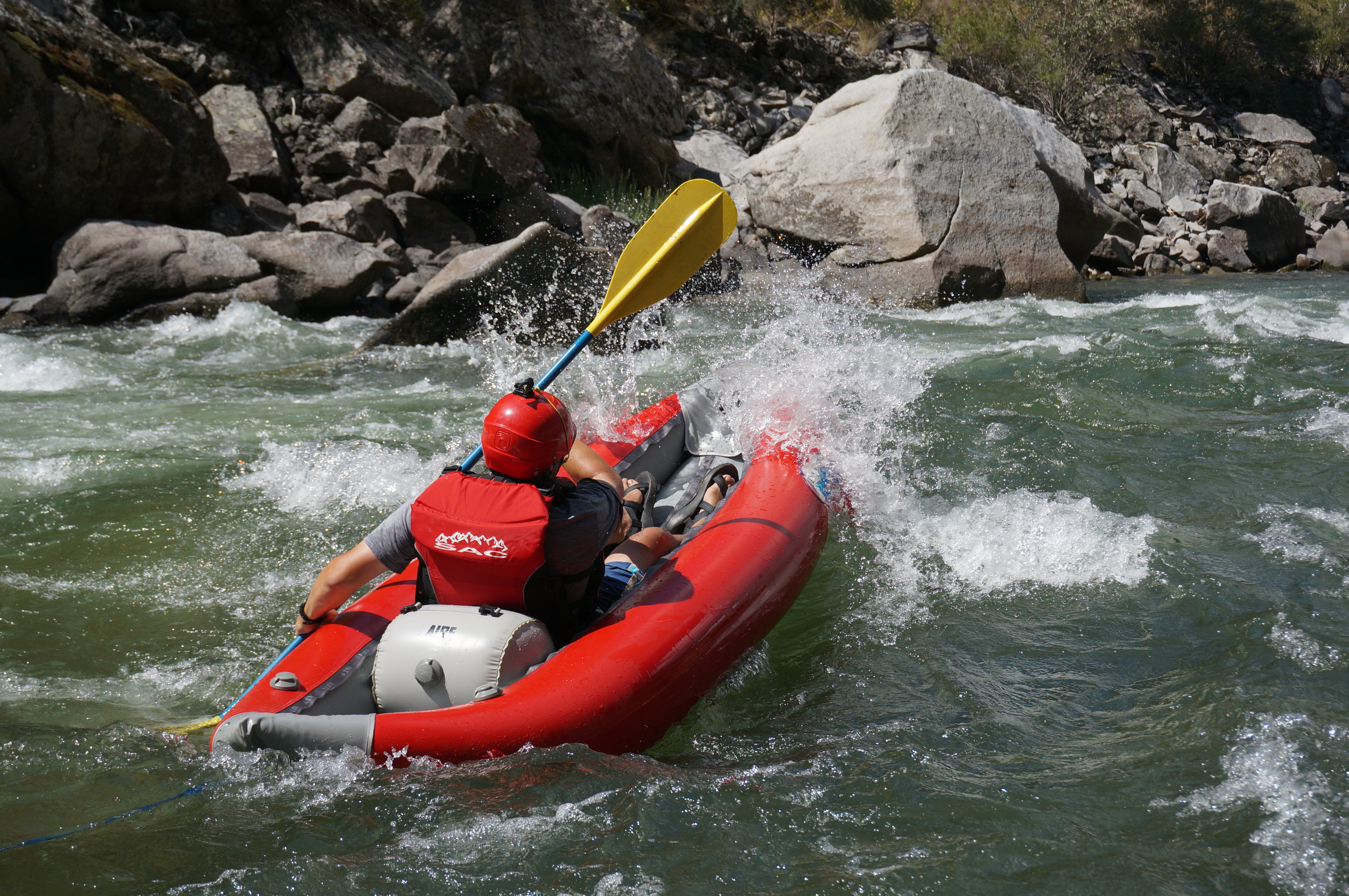 The author, David Goodman, surfs a wave on the Middle Fork.