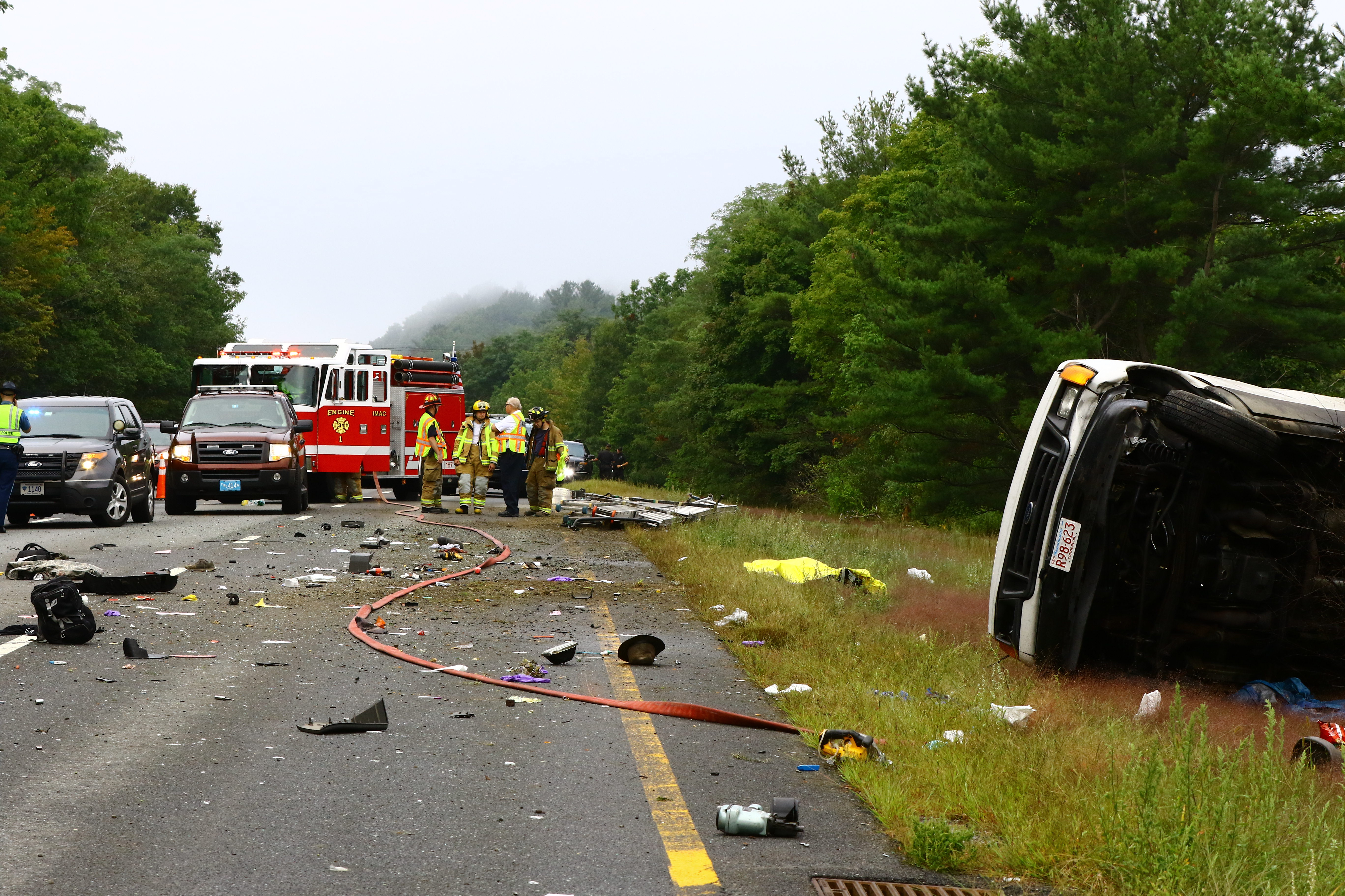 Debris was scattered over the highway after a van carrying six passengers rolled over on Interstate 495 Thursday near Exit 53. At least one person was killed in the crash.