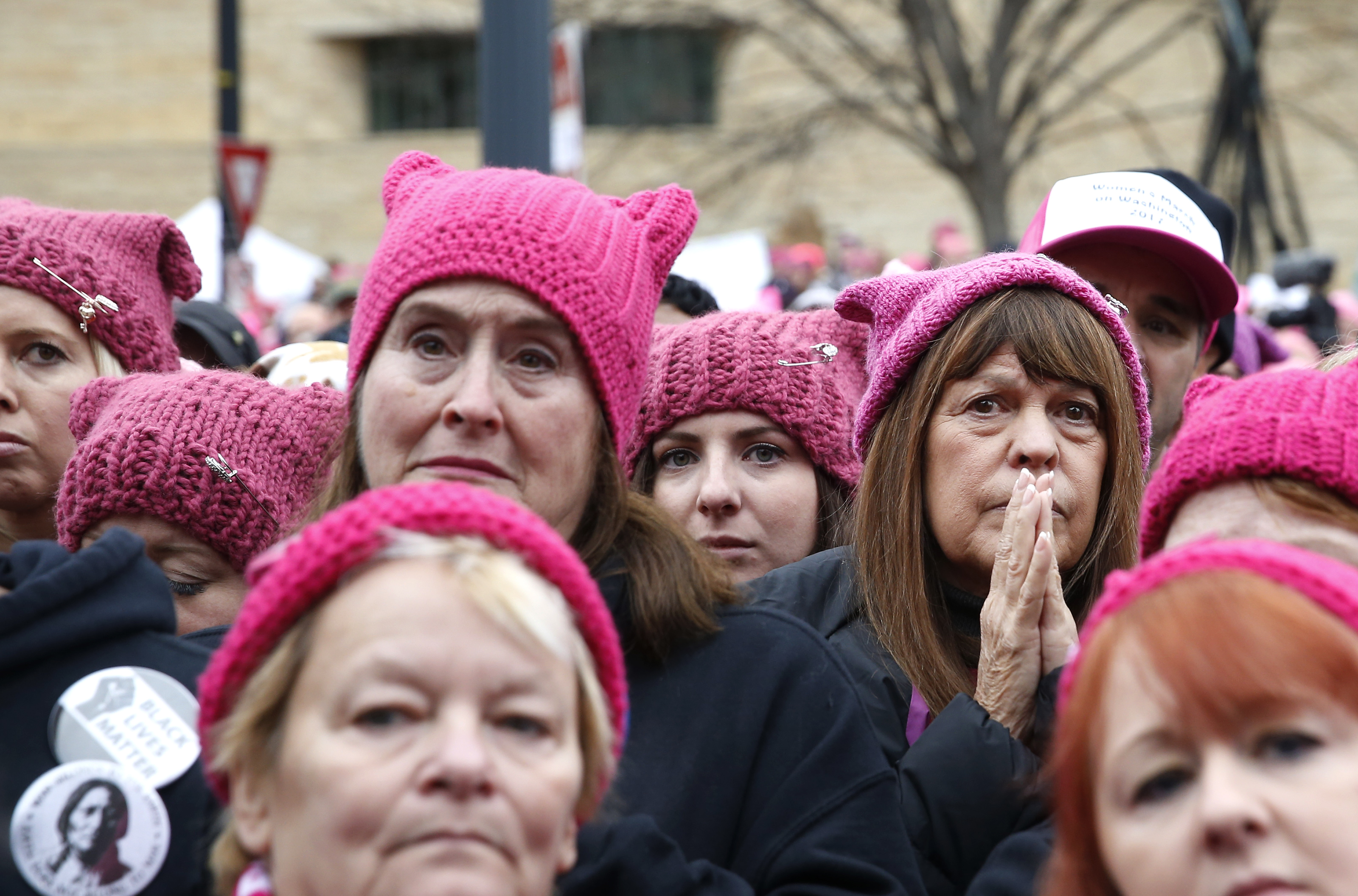 Women clad in pink hats listened to a speaker during the event.