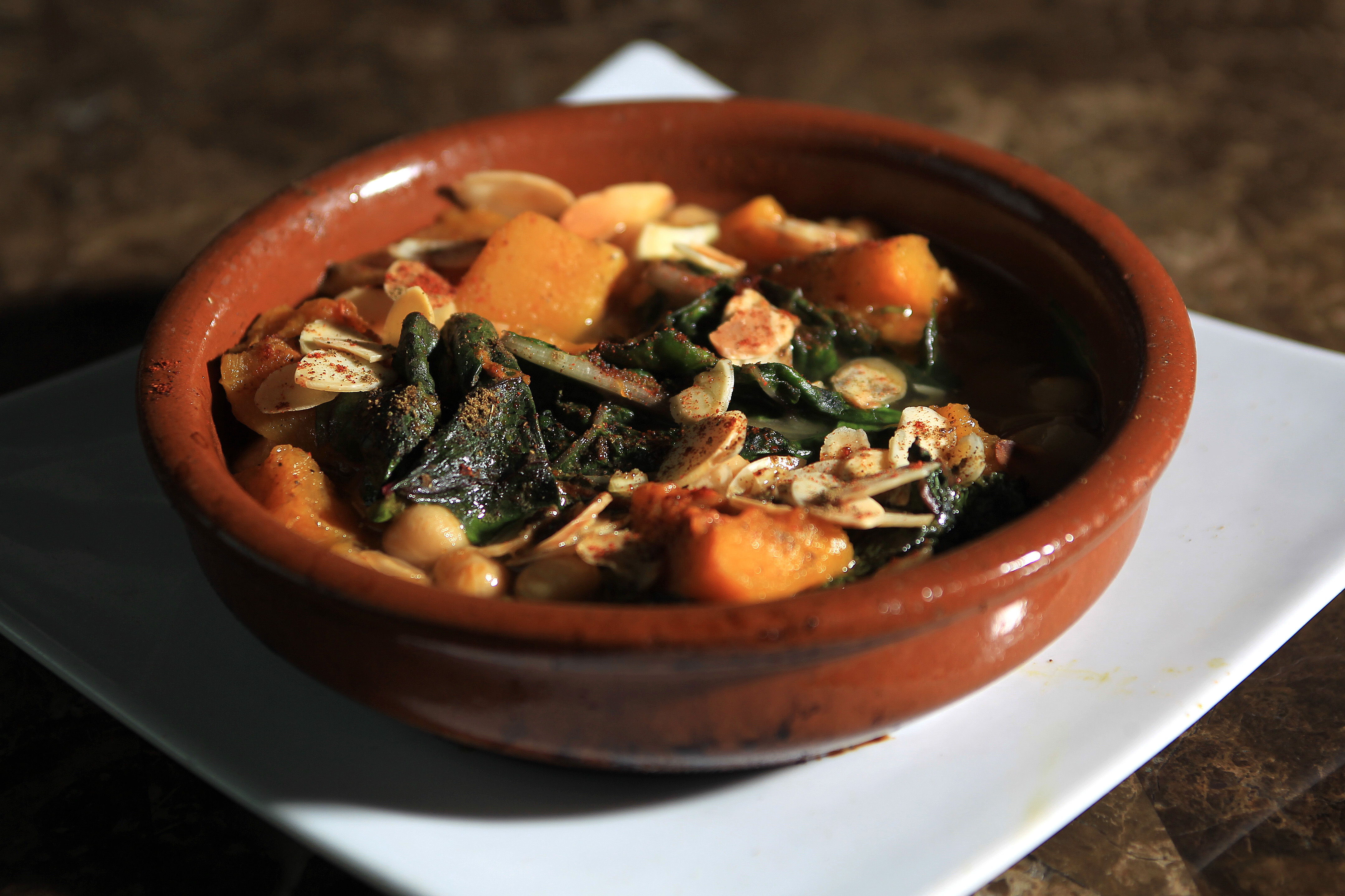 Potaje Andaluz, a dish of sauteed rainbow chard, butternut squash, chickpeas, almonds, golden raisons at Estragon.
