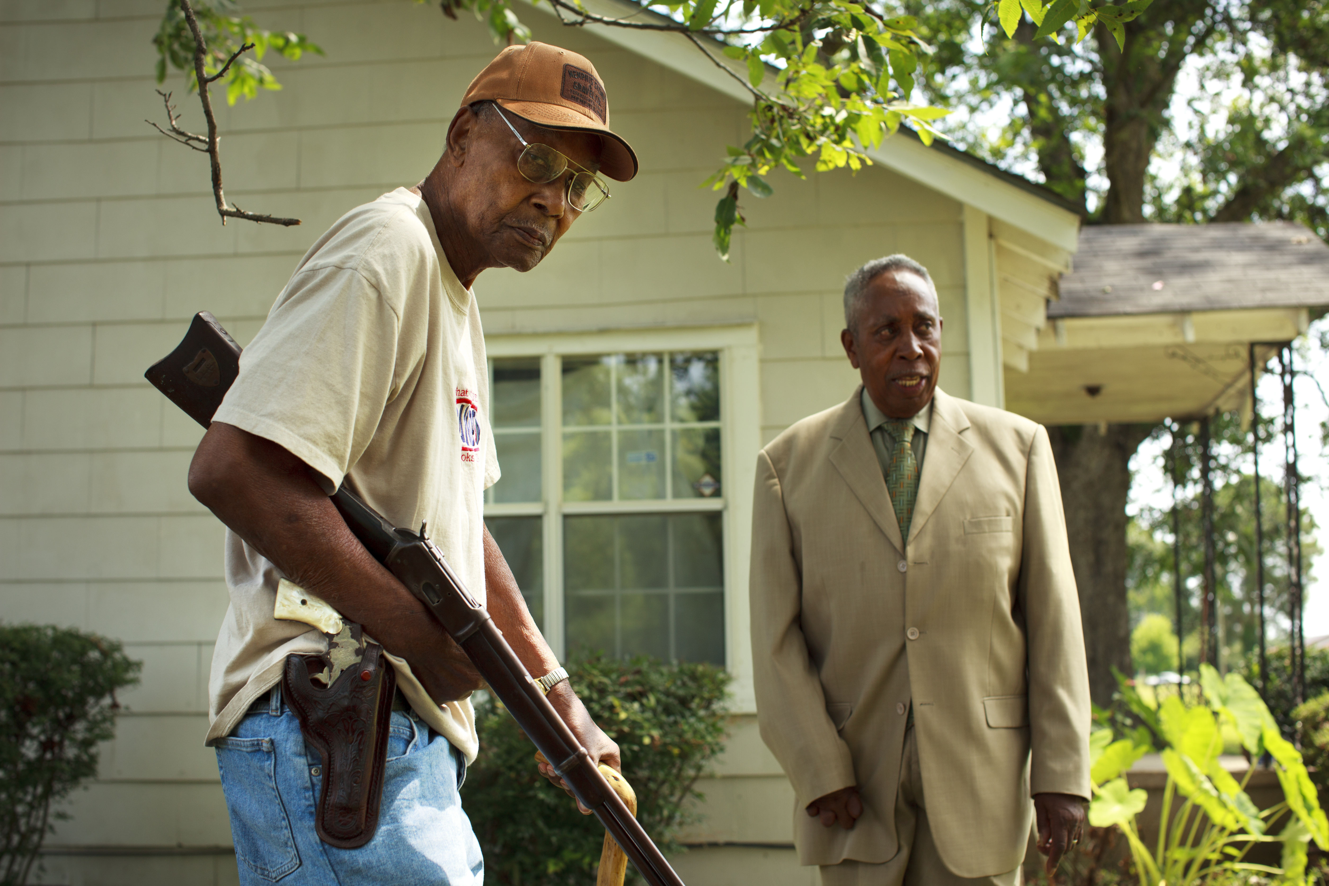 John Watters (left) held two guns he used in 1964 during his shifts standing watch against the Klan along with Robert Miles Jr.