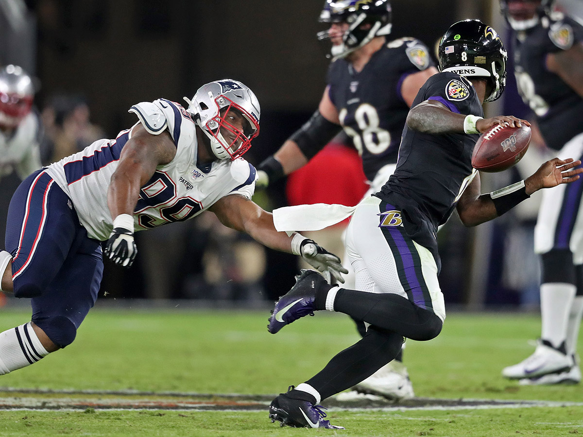Byron Cowart tries to chase down Lamar Jackson.