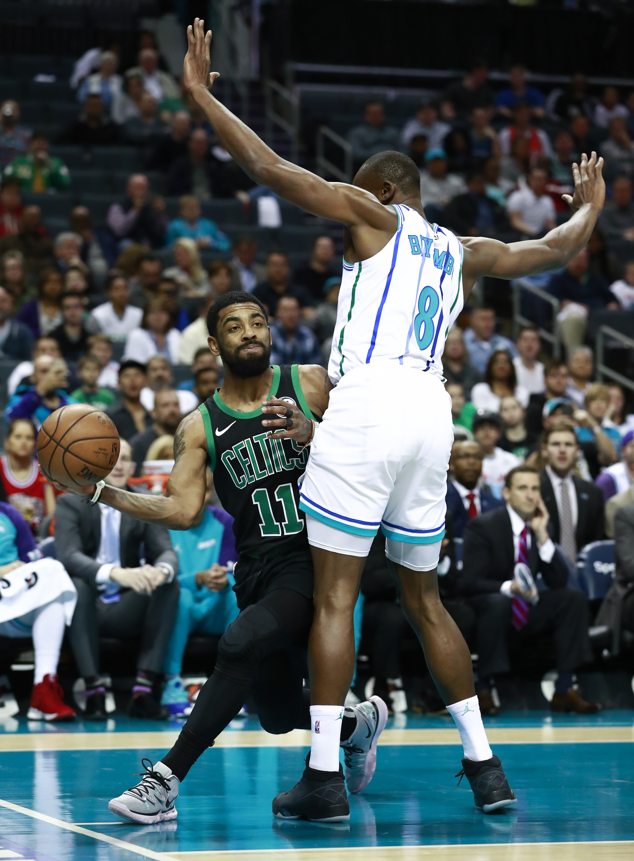 Kyrie Irving, who scored 31 points, passes around Hornets center Bismack Biyombo.