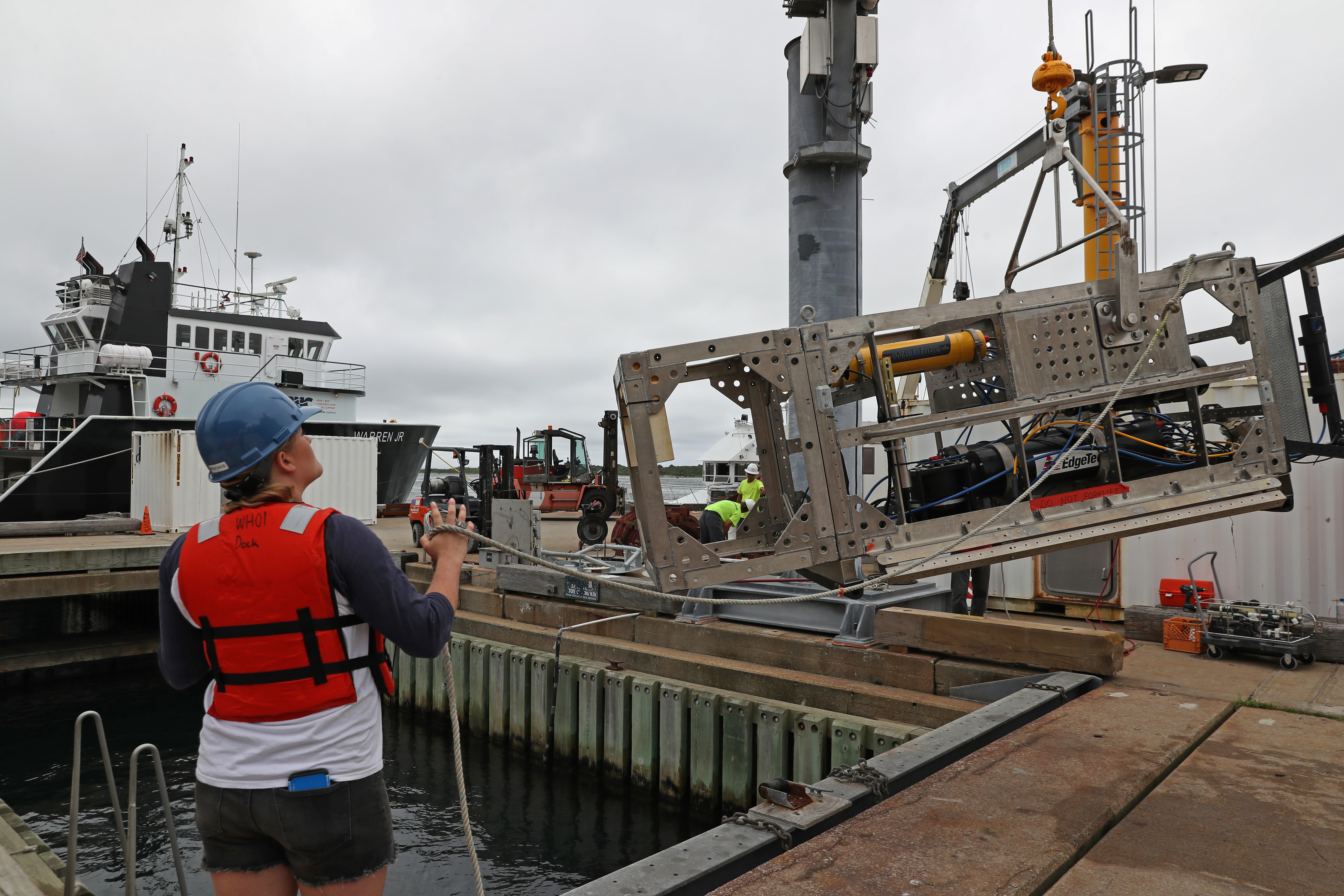 Kaitlyn Tradd, a mechanical engineer at Woods Hole Oceanographic Institution, helped a crane lift DEEP-SEE for testing.